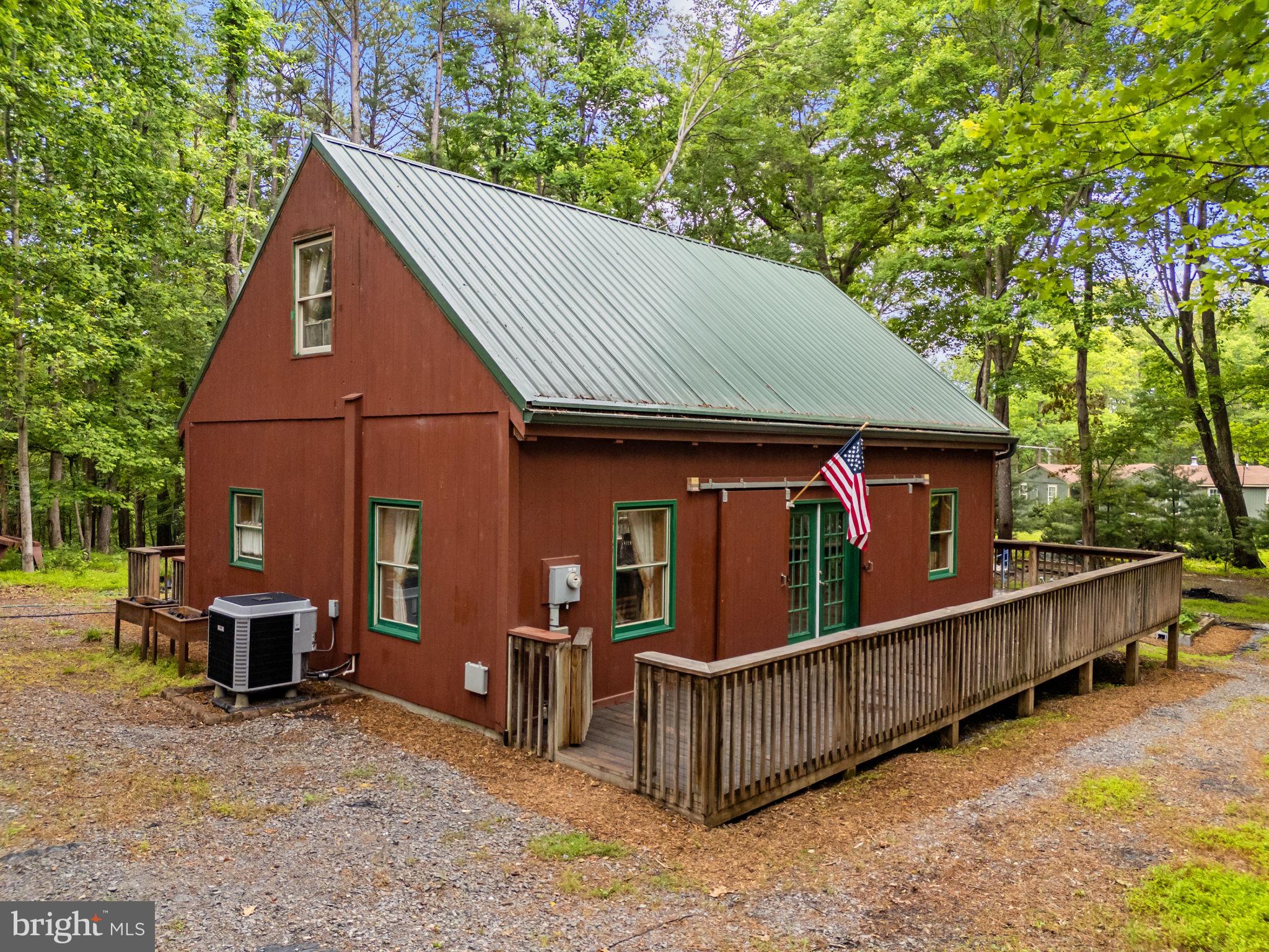 Welcome home to 295 Creekview Ln!  Whether seeking an escape tucked in the woods for a second home, or a permanent respite to relax and call your own, this home has plenty to offer and enjoy.  From the decking which spans 3/4 of the home, walk into an open and spacious living area that has all the cozy feels of a cabin in the woods, simply ready and waiting for you. Lovely Italian Stone tile greets you on the main floor, surrounded by a beautifully built wood interior. With a first floor primary bedroom and en suite bathroom, the home's extra spaces can be used for whatever you envision.  Upstairs you'll find a second loft bedroom also with an en suite bathroom, and it's own private balcony/deck.  Don't need the bedroom? This space is perfect for a creative space, an office, or whatever you desire. Anticipating ample guests and entertaining?  The 2.3+ acres has plenty of opportunity for landscaping and hardscape dreams, and inside can house enough splace to sleep plenty. A special bonus, should you like to expand... the Septic System is installed for a 3 Bedroom home! Another bonus... The current owners have only stained the window sills, welcoming the vision for the next lucky homeowner to stain or color the interior to your liking.  When visiting, take a moment to peek out the picture window in the back of the home, and likely find yourself face to face with beautiful birds and perhaps some wildlife.  This home is absolutely wonderful and ready for you!