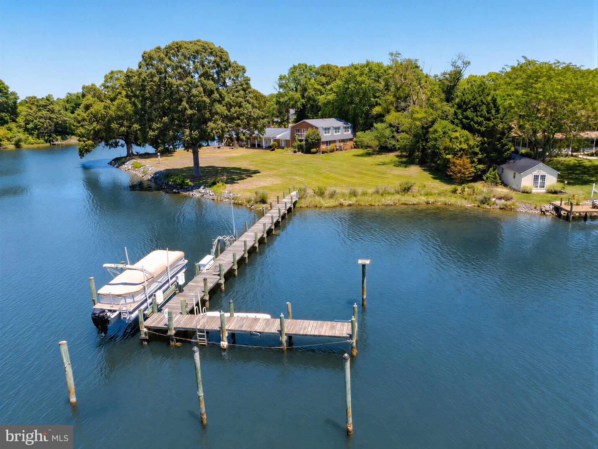 Tucked away on 1.39 private acres with approximately 530 feet of waterfront, this exceptional retreat offers sweeping water views, spectacular sunsets, and direct access just around the bend from the Potomac River. A rare opportunity for boating enthusiasts, the property features a substantial pier with multiple deep-water slips, boat lift, electric, and excellent crabbing and fishing right from your backyard.  

The spacious home offers over 4,700 square feet with 5 bedrooms and 4 full baths, including multiple main-level bedrooms and flexible living spaces designed to capture the waterfront setting. Large windows frame serene water views throughout, while expansive indoor and outdoor entertaining areas create the perfect setting for gatherings, weekend escapes, or full-time waterfront living.  

Originally built in 1974 the property includes a waterside workshop/boathouse, generous parking, and beautifully maintained grounds with mature trees and a gently sloping lawn to the water’s edge. Whether you are looking for a peaceful private residence, a weekend retreat, or the ultimate boating lifestyle, this Southern Maryland waterfront property delivers an unmatched setting