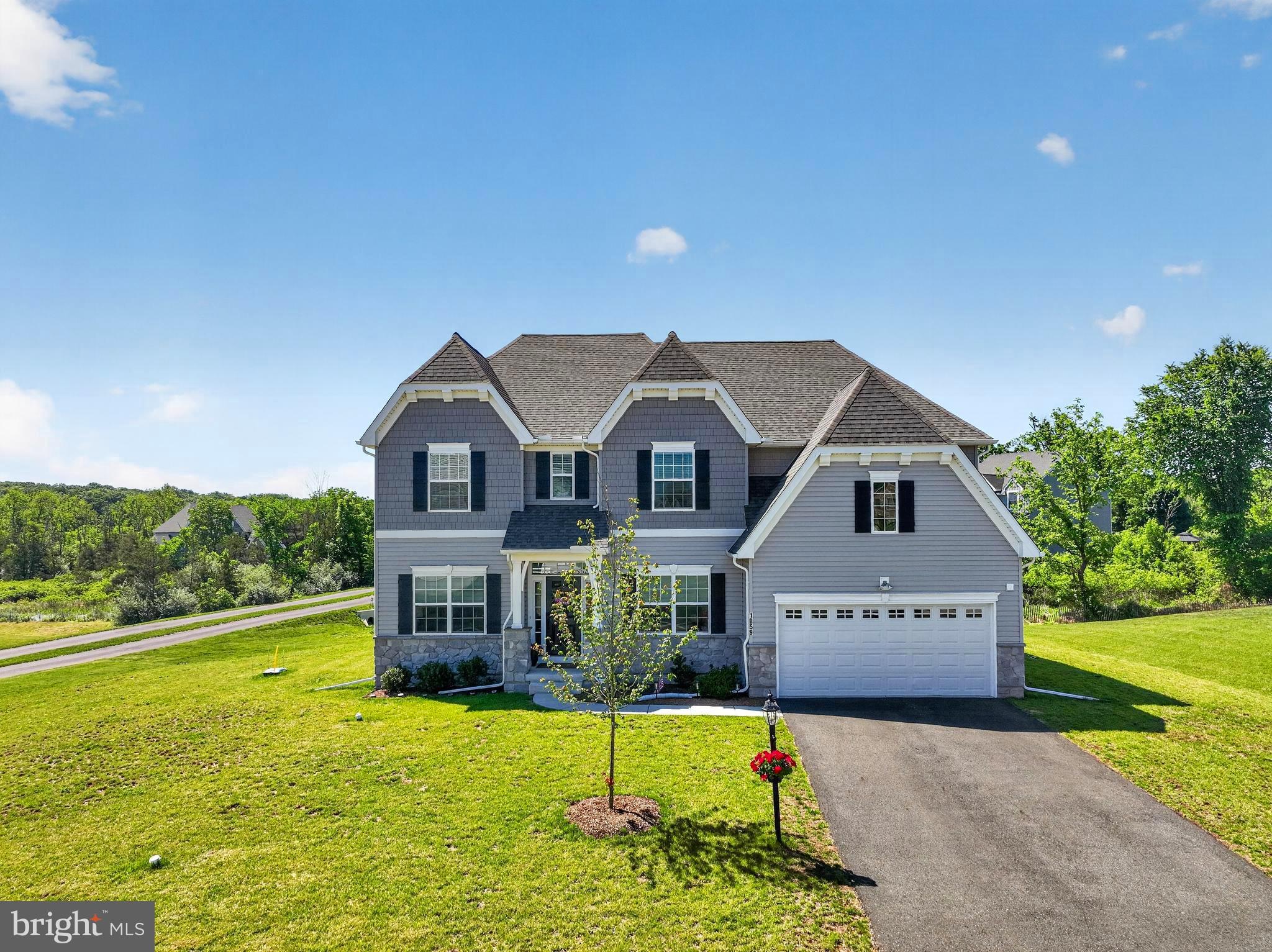 Welcome to 1059 Smyth Lane in beautiful Pennsburg, Montgomery County! Built in 2023, this stunning custom-built home offers 4 bedrooms, 2.5 bathrooms, and an exceptional blend of luxury, comfort, and modern design.
Step inside to find beautiful luxury plank flooring, an elegant custom iron-turned staircase, and soaring 9-foot ceilings throughout the first floor. The spacious layout includes a formal living room, dining room, private office, inviting family room, and powder room.
The gourmet kitchen is truly the heart of the home, featuring quartz countertops, an extra-large center island, farmhouse sink, walk-in pantry, and premium finishes throughout. The adjacent family room boasts a cozy gas fireplace and dramatic floor-to-ceiling windows that flood the space with natural light. Custom draperies and remote-controlled blinds add both convenience and sophistication.
Entertain with ease on the impressive 30' x 16' custom maintenance free deck, offering plenty of room for gatherings with family and friends while enjoying views of the open space beyond. The attached finished two-car garage is enhanced with a durable epoxy-coated floor.
Upstairs, you'll find three generously sized secondary bedrooms, a full hall bath, and a luxurious primary suite complete with spacious walk-in closets and a spa-inspired en-suite bathroom.
The full basement offers endless possibilities with 9-foot ceilings and rough-in plumbing already installed for a future bathroom, making it ready for your finishing touches.
Situated on nearly half an acre, this exceptional property backs to open space, providing a peaceful setting while remaining conveniently located near shopping, dining, parks, and major commuter routes. Don't miss the opportunity to make this nearly new custom home your own!