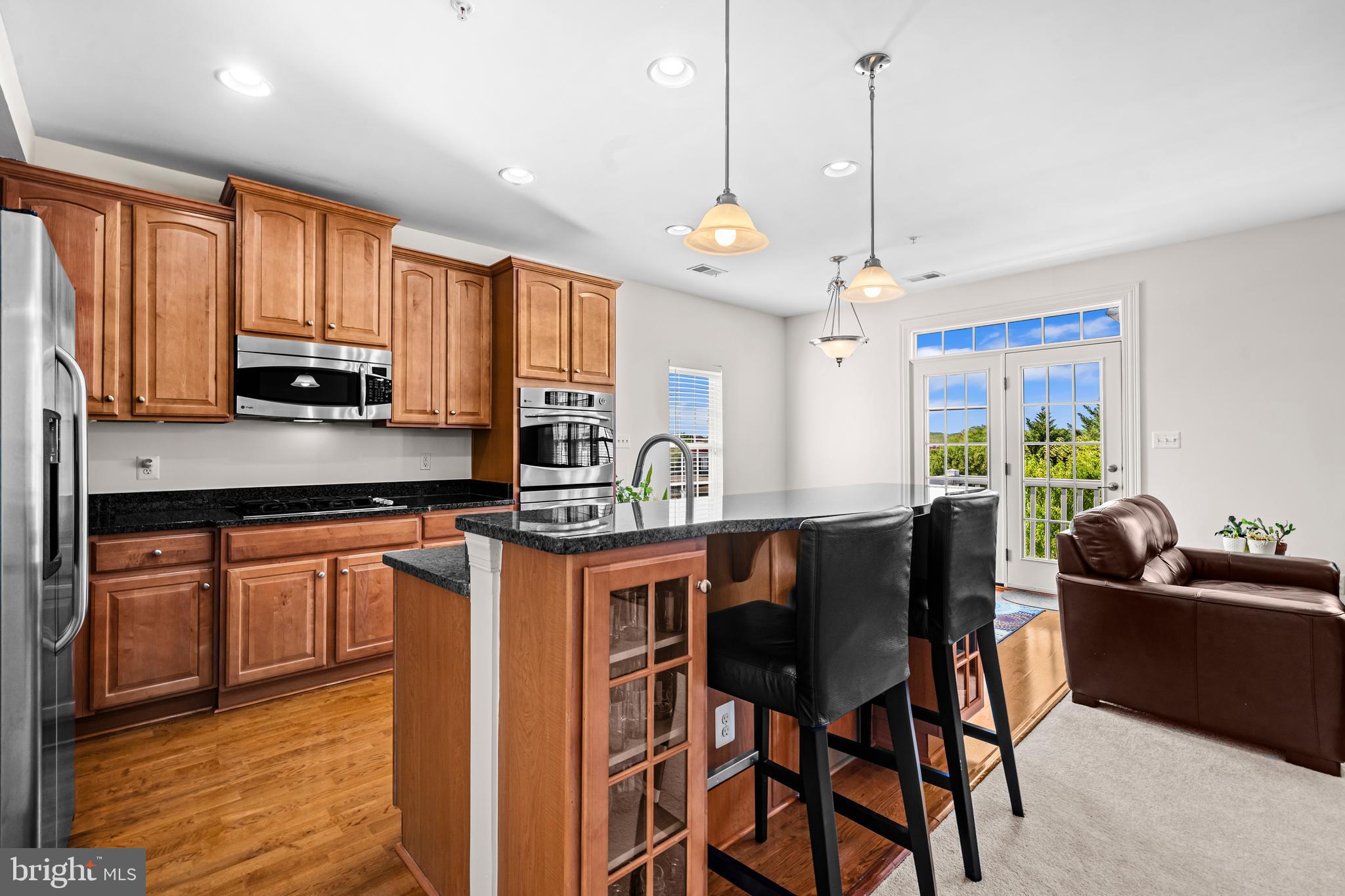 Welcome to this private, end‑unit, top‑level condo—beautifully upgraded and filled with natural light—where every detail is designed to elevate your everyday living experience. Step into the gourmet eat‑in kitchen featuring granite countertops, stainless steel appliances, a double wall oven, pantry, and direct access to the deck, all opening seamlessly to the inviting family room with its cozy gas fireplace.  Enjoy watching beautiful sunsets right from the kitchen windows. The large formal dining and living room combination offers the perfect setting for gatherings, while transom windows and architectural columns add charm and sophistication throughout. The serene primary suite impresses with a tray ceiling, two custom walk‑in closets, and a spa‑like ensuite boasting ceramic tile, dual vanities, and dual shower heads. A dedicated laundry room with stacked washer and dryer and wire shelving adds convenience, and the abundance of sunlight streaming through the picture windows makes every space feel warm and welcoming. 5725 Callcott Way Unit P is a beautifully finished retreat ready to welcome you home.