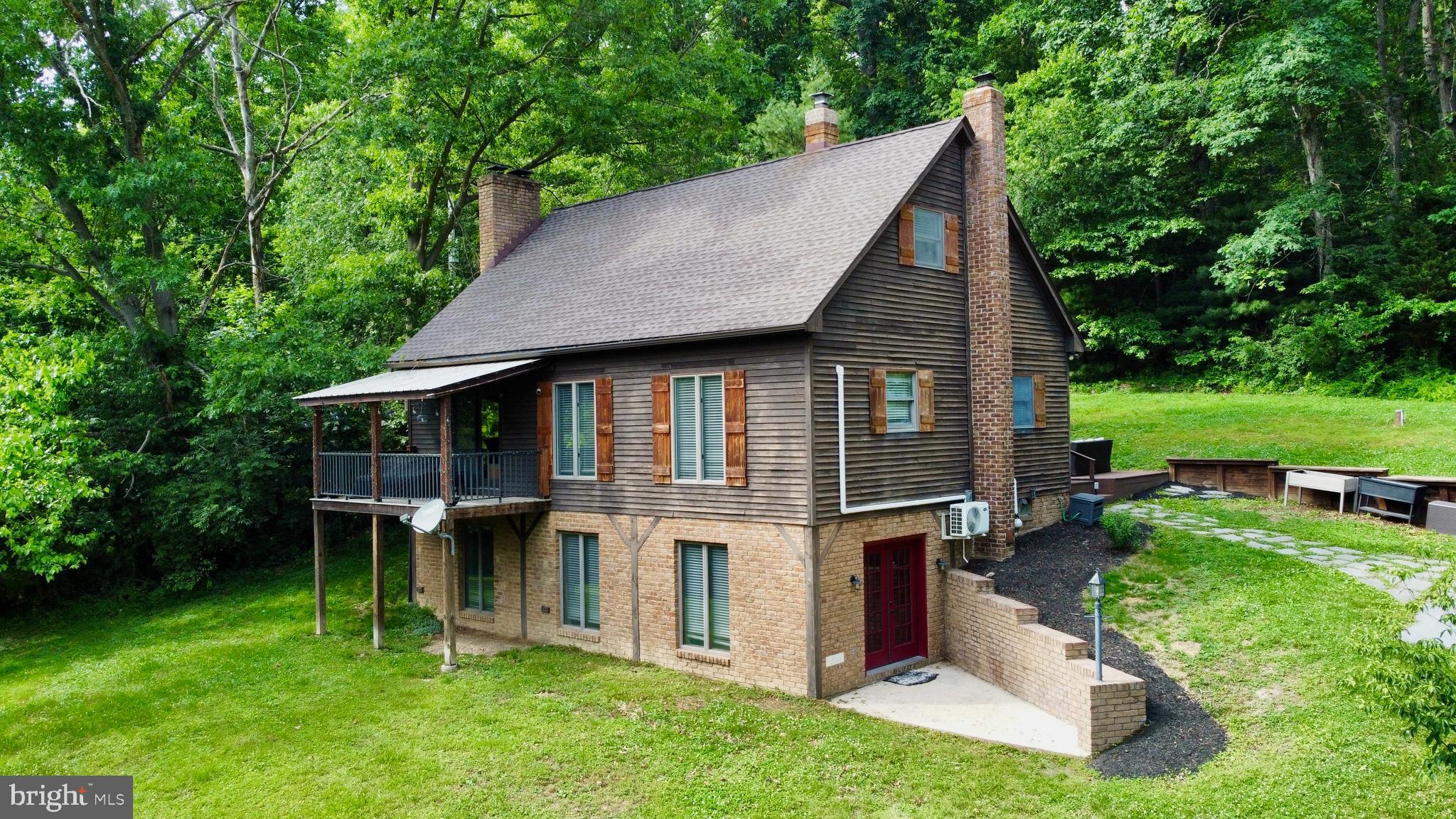 If you are looking for a private and peaceful country setting close to schools and amenities, you just found it ! Situated on over 6 acres this property is  partially wooded with a meadow and a stream. This home features an open floor plan with an upgraded kitchen, exposed wood beams and ceilings, wood floors, a main floor primary bedroom and bath.  Just off the living room you will find a covered porch and from the kitchen you can access a massive deck for entertaining.  The  finished walkout basement provides extra living space with access to the lower patio,  and  a wood stove for cozy heat on those cold winter nights.   Outside you will find plenty of parking for vehicles and even an RV or Boat.  The large pole barn provides plenty of indoor parking for you vehicles, toys and equipment. Checkout the video and schedule your showing so you don't miss your opportunity to make 285 Husson Rd. your new address !