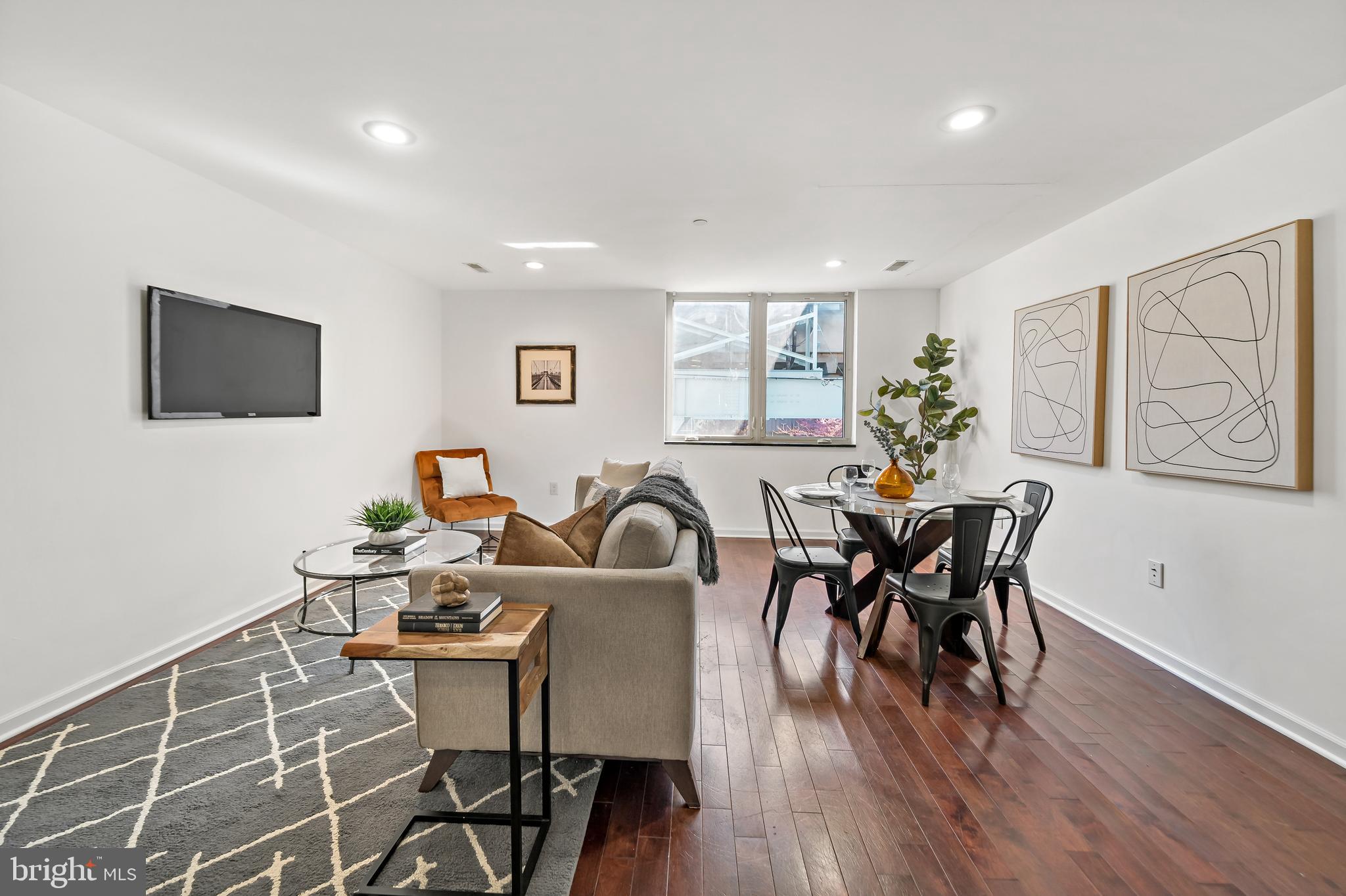 1814 N Front Street, Unit B is a spacious bi-level condominium offering 1,380 square feet, 2 bedrooms, and 1.5 bathrooms in the rapidly growing East Kensington neighborhood. The home features a well-designed layout, modern finishes, and shared pilot house access to a roof deck with skyline views.

The main living level is bright and open, with ceramic tile flooring, high ceilings, and large windows that bring in strong natural light throughout the day. The kitchen is designed for both everyday living and entertaining, with quartz countertops, stainless steel appliances, custom cabinetry, and an island with a raised seating edge that provides convenient space for casual dining.

The upper level includes two generously sized bedrooms with ample closet space and separation from the main living area for privacy. The full bathroom features contemporary fixtures and modern tilework. Additional highlights include a powder room on the main level, in-unit washer and dryer, central air, and efficient modern systems.

Residents also enjoy access to a shared pilot house leading to the roof deck, offering open city views and outdoor space for relaxing or gathering.

Located just steps from the Berks Station on the Market–Frankford Line, the property provides direct access to Center City in minutes. The surrounding blocks offer excellent walkability to Fishtown and East Kensington’s restaurants, cafés, galleries, and neighborhood amenities, making it a convenient and connected place to live.