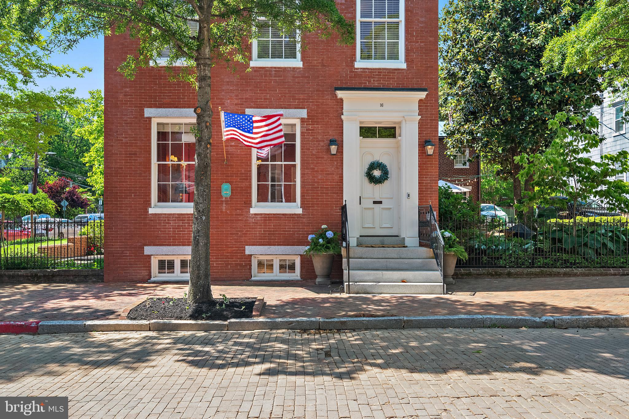 A truly exceptional historic residence is now available in the heart of downtown Annapolis. Welcome to 16 Maryland Avenue, a distinguished circa-1830 Greek Revival home masterfully restored in collaboration with the renowned Hammond-Wilson Architects. Perfectly positioned just steps from State Circle and the United States Naval Academy, this iconic three-story brick property seamlessly blends timeless architectural beauty with sophisticated modern livability.
The main property features 4,474 square feet of refined above-grade living space, complemented by a fully legal, licensed lower-level apartment that offers immense versatility for multi-generational living or premium rental income. In total, the property features six bedrooms, 4.5 bathrooms, and beautifully curated living spaces defined by rich period details, soaring ceilings, and remarkable craftsmanship. Six fully rebuilt, functional wood-burning fireplaces (three equipped with gas starters) serve as stunning architectural focal points throughout the home.
Equally captivating are the enchanting outdoor spaces. Here, manicured grounds, lush landscaping, vibrant flower beds, and a serene koi pond create a private garden retreat rarely found downtown. Set on a prime 7,324-square-foot lot along one of the city’s most coveted historic streets, the property offers tranquility just moments from the waterfront and bustling downtown scene.
Zoned as a two-family residence, this remarkable property represents a rare, premium investment or a luxurious private estate. Residents will enjoy an unmatched lifestyle, surrounded by boutique shopping, acclaimed waterfront dining, art galleries, historic landmarks, and the unmistakable charm of Annapolis Harbor. Elegant, iconic, and rich with history, 16 Maryland Avenue represents downtown Annapolis living at its absolute finest.