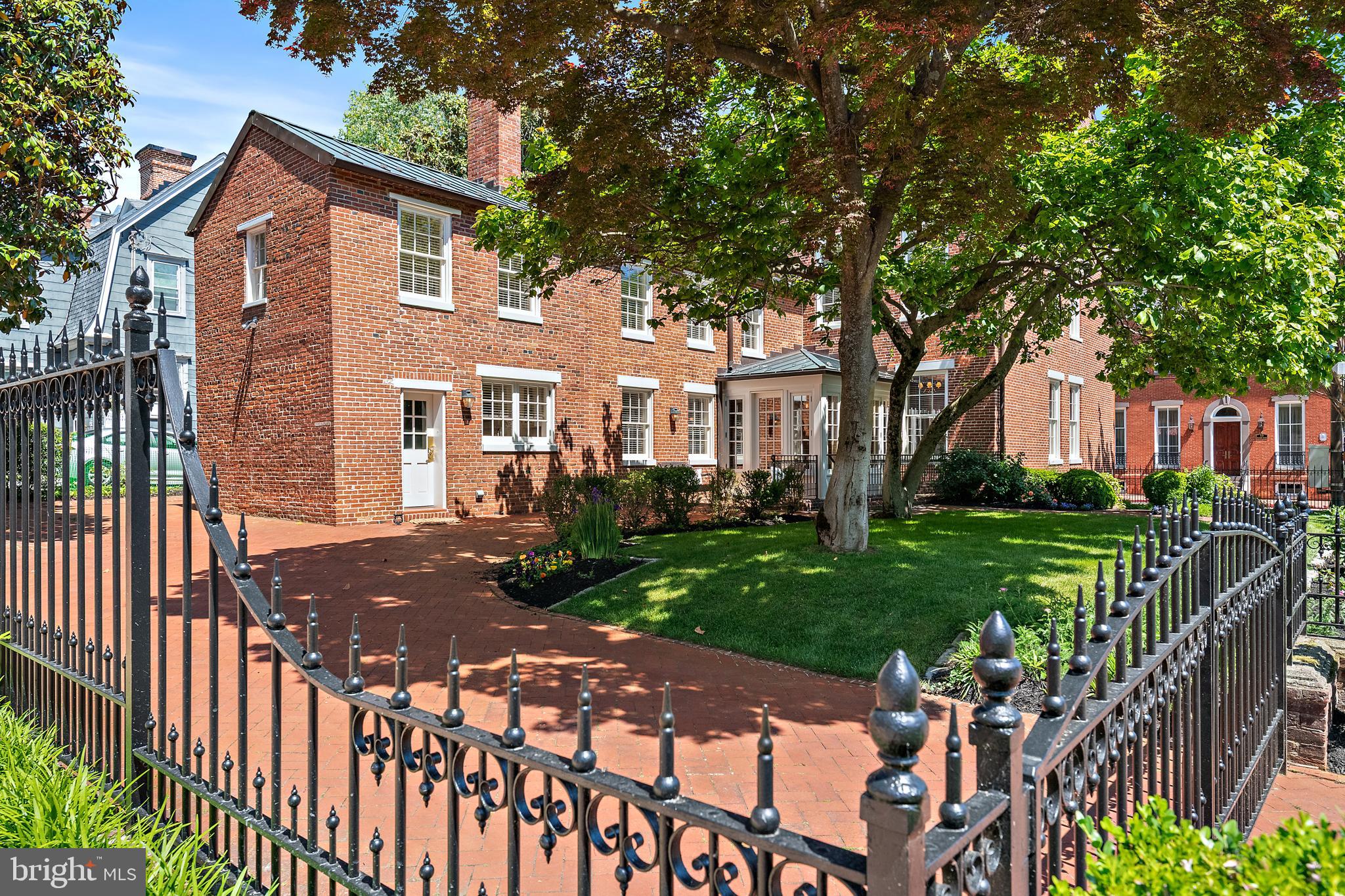 A truly exceptional historic residence is now available in the heart of downtown Annapolis. Welcome to 16 Maryland Avenue, a distinguished circa-1830 Greek Revival home masterfully restored in collaboration with the renowned Hammond-Wilson Architects. Perfectly positioned just steps from State Circle and the United States Naval Academy, this iconic three-story brick property seamlessly blends timeless architectural beauty with sophisticated modern livability.
The main property features 4,474 square feet of refined above-grade living space, complemented by a fully legal, licensed lower-level apartment that offers immense versatility for multi-generational living or premium rental income. In total, the property features six bedrooms, 4.5 bathrooms, and beautifully curated living spaces defined by rich period details, soaring ceilings, and remarkable craftsmanship. Six fully rebuilt, functional wood-burning fireplaces (three equipped with gas starters) serve as stunning architectural focal points throughout the home.
Equally captivating are the enchanting outdoor spaces. Here, manicured grounds, lush landscaping, vibrant flower beds, and a serene koi pond create a private garden retreat rarely found downtown. Set on a prime 7,324-square-foot lot along one of the city’s most coveted historic streets, the property offers tranquility just moments from the waterfront and bustling downtown scene.
Zoned as a two-family residence, this remarkable property represents a rare, premium investment or a luxurious private estate. Residents will enjoy an unmatched lifestyle, surrounded by boutique shopping, acclaimed waterfront dining, art galleries, historic landmarks, and the unmistakable charm of Annapolis Harbor. Elegant, iconic, and rich with history, 16 Maryland Avenue represents downtown Annapolis living at its absolute finest.