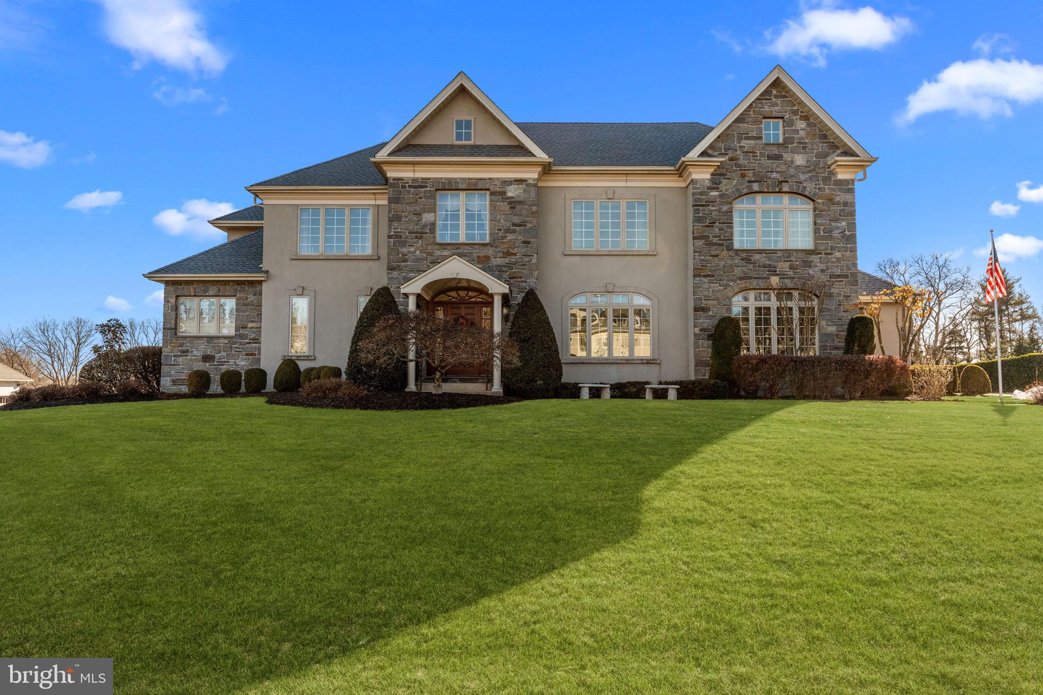 Experience exceptional living at 2175 Jefferson Lane, a beautifully maintained custom-built residence located in the highly sought-after Lower Moreland School District. Built by  builder Dave Della Porta, this expansive home combines quality craftsmanship, thoughtful design, and the space today’s buyers are searching for. Offering 5 bedrooms and 6 bathrooms, the home welcomes you with a dramatic entrance, rich Bruce hardwood flooring, and an impressive open-concept layout. The two-story family room serves as a stunning focal point, featuring soaring ceilings, a gas fireplace, and an elegant overlook from the second floor that fills the space with natural light. Designed for both everyday living and entertaining, the spacious kitchen is equipped with double wall ovens, a 5-burner gas cooktop, abundant cabinetry, generous prep space, and a large center island that naturally brings family and guests together. The first-floor owner’s suite provides comfort and convenience with oversized walk-in closets and a luxurious private bath. A sound-insulated bedroom on the main level offers endless possibilities as a home office, guest quarters, or flexible living space. The upper level features four additional bedrooms, multiple bathrooms, and ample storage, providing plenty of room for growing families or visiting guests. Downstairs, the finished basement expands your living space with a wet bar, recreation area, and plenty of room for entertaining, gaming, exercising, or creating the ultimate media room. Step outside to a spacious rear deck overlooking the beautifully landscaped yard, creating the perfect setting for outdoor dining, relaxing evenings, and weekend gatherings. An irrigation system helps keep the grounds looking their best year-round. Additional features include a 3-car attached garage, oversized driveway with parking for up to 10 vehicles, HVAC system installed in 2016, and a brand-new roof completed in June 2025. A rare offering in a premier location, 2175 Jefferson Lane delivers the perfect combination of space, quality, and lifestyle. Schedule your private showing today.