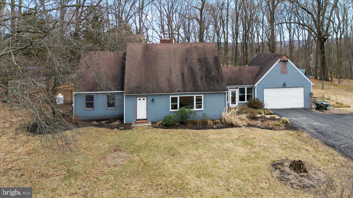 Builders, Visionaries, and Doers, we have Location, privacy, and are surrounded by nature.  This 3 bedroom, 2 bath cape style home offers an opportunity to create the home you've dreamt of on over 8 acres in Buckingham Township. Pull into your driveway,  and as you do, envision the fun and beauty that can be had on this property, especially how ideally situated  this home is . Your views are picturesque with each seasonal change. Take a walk to your main entrance and when you open the door, the wood floors adorn the foyer straight ahead and the living room off to your right. This brightly lit room with custom built in cabinetry  adds  function to this gathering space where you will envision cozy nights by the wood burning stove  and time with those you treasure most, The adjacent, eat-in kitchen with large tile flooring, stainless steel appliances and counter space is ideal for prepping some of your favorite meals and catching up on the days happenings while around the island or at the table. The kitchen looks out to your yard with a fenced in area and additional lush grass area to enjoy a multitude of activities.  The mudroom surrounded by windows provides an abundance of natural light and can be accessed from the kitchen, garage, rear yard, and the front of the home. This room can function to fit your interests and lifestyle and has been a craft room retreat where hours of enjoyment was had. 
Finishing off the main level is a spacious bedroom (was two rooms and wall was removed) and a full spa-like bathroom with a large glass-enclosed shower with a rain-shower head and intricate tile-work.  
Upstairs  you will find two additional bedrooms that share a full bath and views of all the land that surrounds your home. The full basement provides access to the exterior of the home and plenty of storage. 
 Centrally located to restaurants, stores, Route 202, Peddlers Village, New Hope and more, and within Central Bucks School District .