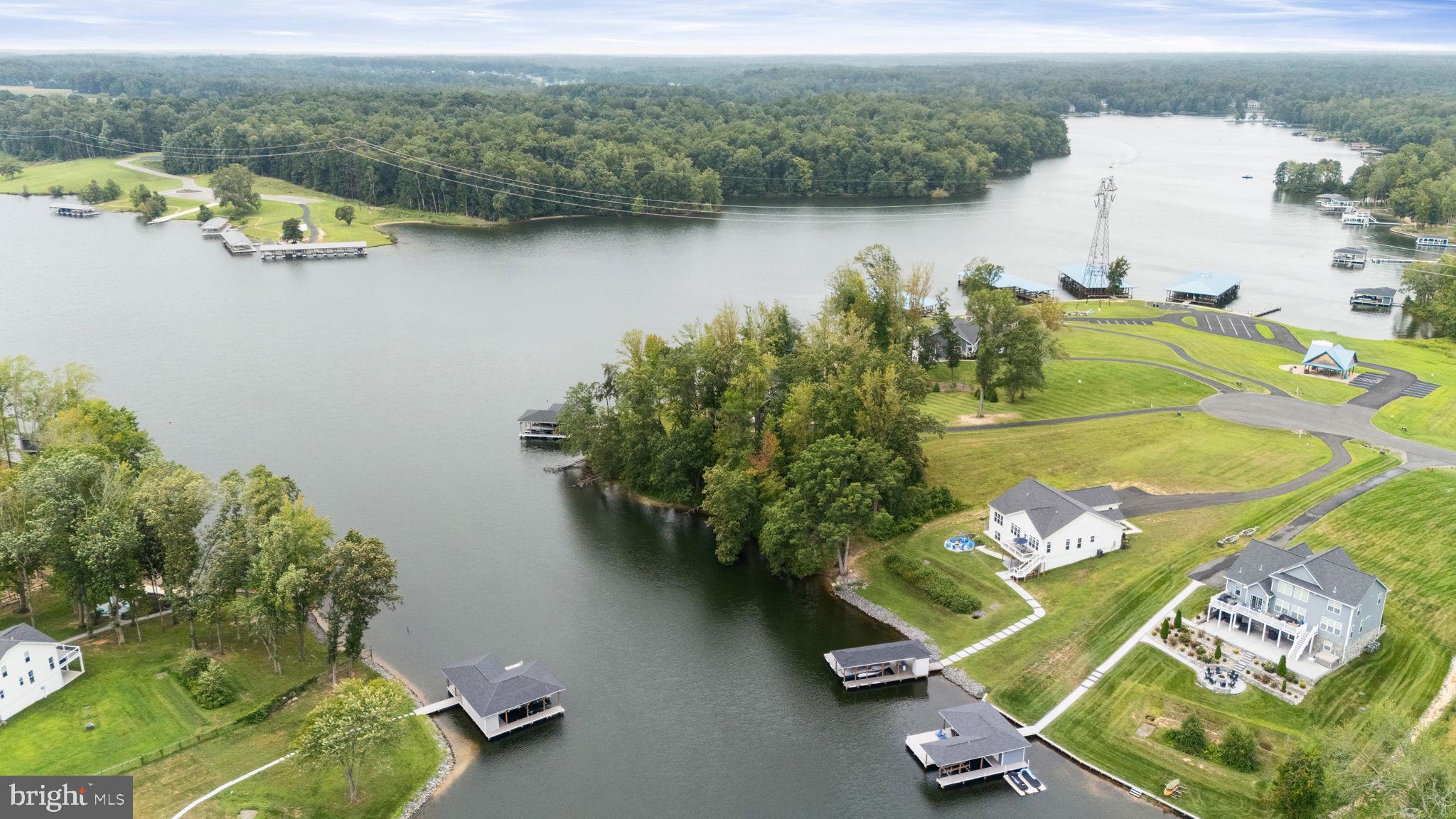 NEW PRICE!  Motivated Seller!!!  Welcome to waterfront luxury living at beautiful Lake Anna. This property is available as a fully furnished option, giving buyers the convenience of a true turn-key, move-in-ready lake home!!!  This like-new craftsman-style retreat is just two years old and offers breathtaking views, an open floor plan, and sought-after main-level living.  Inside, you’ll find over 4,000 square feet of thoughtfully designed space with 5 bedrooms and 4 bathrooms. The gourmet kitchen features upgraded cabinetry and hardware, sleek quartz countertops, and a large center island perfect for entertaining. The spacious primary ensuite provides comfort and privacy, while additional rooms include an office and a media room that can serve as overflow guest spaces. (Approved for a 4-bedroom septic system.) The exterior showcases durable Hardieplank fiber cement siding and professional hardscaping, combining timeless curb appeal with low-maintenance protection. From the walk-out lower level—or stairs off the back deck—follow the paved path to a waterside fire pit and 150 feet of rip-rapped shoreline. The private boathouse includes a 28-foot covered slip with a 6,500-lb electric lift and a sundeck over water approximately 7 feet deep. Nestled just off the main lake, this peaceful setting is ideal for swimming, floating, and quiet relaxation. The community allows short-term rentals but is largely homeowner-occupied, offering a balance of full-time residents and upscale weekend retreats. Amenities include a waterfront common area with a picnic pavilion and boat ramp. Ideally located, the home is just 45 minutes to Richmond, 90 minutes to Washington, D.C., 7 miles to local dining favorites (Lake Anna Taphouse, Vito’s, Asian Café), less than a mile to Elk Creek Country Store and gas, and approximately 5 miles to New Bridge Landing Shopping Center for groceries, restaurants, and more. For investors, Lake Anna was recently ranked the #1 short-term rental destination in the nation—making this property an exceptional income-producing opportunity.  Furnishings, modern coastal décor, kayaks, and more can convey to create a seamless transition for the next owner.