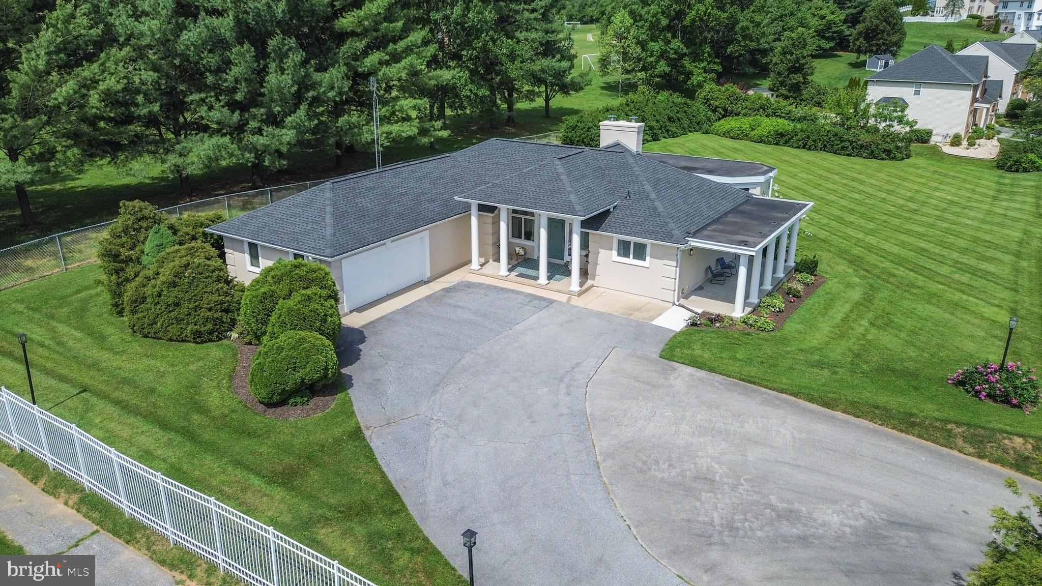 You've seen this one. If you've driven through Westminster, you've slowed down to admire it — the stately columned portico, the sweeping covered porch, the light-filled sunroom rising above the deck. Now it's your turn to step inside. One of Westminster's most recognizable homes, this distinctive 3-bedroom, 2.5-bath single-level residence lives as beautifully as it looks. A grand columned entry opens to a generous living room with soaring 10-foot ceilings and signature arched windows, full of natural light and easy flow. The kitchen offers abundant white cabinetry and a breakfast bar, with a dining area that opens to a cozy sunroom and out to the deck beyond. A smart split-bedroom layout places the primary suite on its own private wing — complete with its own bath, walk-in closet, two linen closets, and access to the deck and sunroom — while two additional bedrooms and a full hall bath sit on the opposite side of the home, ideal for guests, family, or a home office. Out back, a one-of-a-kind sunroom wrapped in windows — over 27 feet long and 14 feet wide — sits surrounded by an expansive deck you can stroll nearly all the way around. It's a rare, flexible space overlooking lush, level grounds that back to mature trees, all set on roughly three-quarters of an acre with no HOA — a rare amount of room and freedom in this established neighborhood. Downstairs, a massive unfinished basement is a blank canvas with room to grow — finish it for a rec room, home gym, or in-law space, with potential to add a full bath. A two-car garage, a covered front porch, a dedicated laundry room, and a charming powder room round out comfortable one-level living. Even better, the big-ticket items are done: newer roof, HVAC, hot water heater, and both full baths updated, plus many additional upgrades throughout. A home this distinctive doesn't come along often. Come see it.