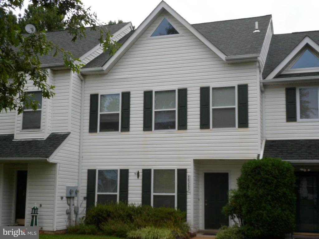 Charming town home located in beautiful water privileged community.  Low maintenance, easy commute to Pax,  and nearby sandy beach- providing  true relaxation.  This home also offers three bedrooms plus a generous loft plus.  Fenced yard backing to trees gives you the privacy you need. Great patio