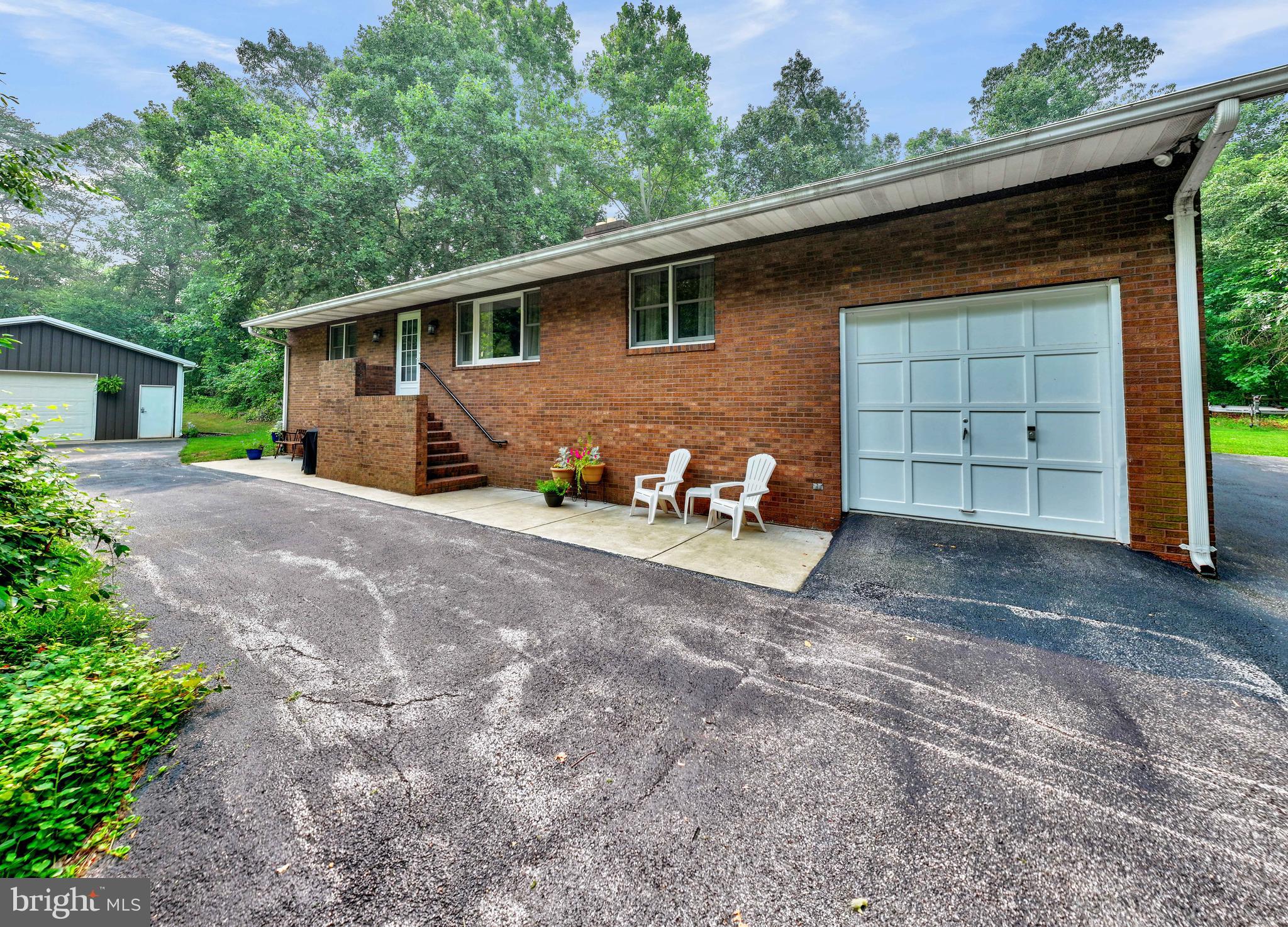 A rare opportunity with endless potential! Nestled on 2 private, wooded acres, this unique rancher offers the perfect blend of peaceful seclusion and exceptional convenience to major commuter routes, BWI Airport, Arundel Mills and Ft Meade.

The home features 3 bedrooms, 2 full bathrooms, an attached one-car garage, a finished lower level, and an abundance of storage throughout. Outside, you’ll find an impressive 24x44 oversized detached garage/workshop complete with its own full bathroom—an incredible space for hobbyists, contractors, car enthusiasts, or anyone needing a serious workspace.

What truly sets this property apart is its W-1 (Industrial Park District) zoning. While the property has always been used as a residence, the zoning may provide unique opportunities for investors, entrepreneurs, or business owners seeking a live/work environment or commercial possibilities. Buyers should verify all permitted uses with Anne Arundel County.

With extensive parking, a private setting surrounded by nature, and incredible flexibility, this one-of-a-kind property offers possibilities rarely found in today’s market. Whether you’re searching for a private residence, an exceptional workshop, investment potential, or a property that can accommodate your business vision, 7143 Race Road is ready to inspire your next chapter.