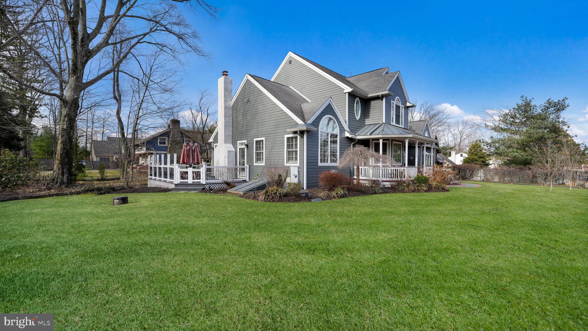 The Home You’ve Been Waiting For! Nestled in the heart of Doylestown Boro, this stunning 4 bedroom, 4.5 bathroom cape style home offers the perfect blend of elegance, comfort, and modern convenience. With a finished lower level, oversized two-car garage, and a wraparound composite deck, this home is designed for both everyday living and exceptional entertaining.
As you arrive, the beautifully landscaped grounds provide a sense of privacy and charm. A winding paver walkway leads to the inviting covered front porch, an ideal spot to enjoy your morning coffee. Step inside to an open-concept floor plan with soaring ceilings, engineered hardwood floors, and abundant natural light. Large windows frame picturesque views, while multiple doors provide seamless access to the expansive side and back deck. The plantation shutters throughout are a special touch.
At the heart of the home is the gourmet kitchen, a chef’s dream with generous cabinetry, plenty of counter space, stainless steel appliances, double ovens, and a Viking five-burner stove. Adjacent, the family room with a gas fireplace offers a cozy retreat on cooler days. Step outside to your wraparound deck, complete with a pergola, retractable awning, and subtle low-grade lighting that creates a magical ambiance at night, overlooking a gently flowing stream. A new hot tub and a fenced-in backyard add to the outdoor oasis.
Upstairs, the luxurious primary suite boasts a sitting area, his/her closets, and a spa-like bathroom with an oversized shower and freestanding soaking tub. Three additional bedrooms complete the second level, including a junior suite with a private bath and a Jack and Jill bathroom connecting the other two rooms.
The finished lower level is a true bonus, featuring luxury vinyl flooring, built-in bookcases, a full bathroom, and two dedicated storage areas—perfect for a media room, gym, or guest suite.
Extensive landscaping includes dogwood trees, hydrangea, wisteria, evergreens, ferns and spring bulbs. Located in a fabulous location less than one mile from downtown Doylestown and conveniently located for shopping with two restaurants at the end of the street. Adjacent to Font Hill Park and many walking trails. This home has been lovingly maintained with numerous updates over the years. Contact us for a full list of improvements and schedule your private showing today!