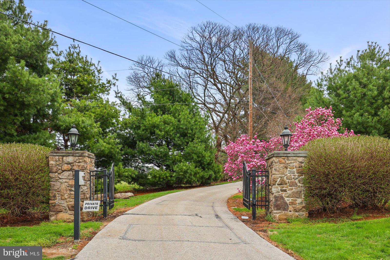 If you value privacy, exquisite views and a resort lifestyle, then look no further as this regal estate, high on the hill is sure to please!  With attention to every detail, this property presents an unmatched level of impeccable design. Enter through a gorgeous masonry pillared gate and be impressed by the tree-lined entryway as you are greeted with breathtaking views that go on for miles. Luxury exudes all around you on this 10+ acre, resort-style residence. An expansive renovation of the entire property showcases this one-of-a-kind custom property for one with distinguished taste. Enter through the double doors to the grand two-story foyer featuring two closets and a settee. Go upstairs and discover two bedrooms complete with walk-in closets and a full bath or continue on the first floor to the massive main living room area with exposed wood beams, a fireplace with beautiful stonework and even a wet bar to service this room. Follow the French doors to the dining room and discover the wall of windows with the extensive, scenic views on full display. Here you will also find a multi-level outdoor terrace, with landscaping to complement the round paved terrace leading to the pool.  Also in the dining room is a bar pass-thru and plenty of room to entertain noted by the oversized dining room table. The kitchen boasts beauty and grandeur that any chef would love. With a portable island, ss appliances and an imported backsplash from Italy, this bright and welcoming kitchen will make creating dinners a delight. The first-floor primary ensuite features 4 closets, 2 sinks, a vanity, dual shower heads, soaker tub, linen closet, and a separate WC. A delightful office space with built-ins and a powder room across the hall make the owners wing a private, personal space. Stroll down the hall to the East Wing and on your way find the meditation room. Here you can enjoy your morning workout with a large fountain, plant life, a 6-person sunken hot tub and powder room. There is a massive dome style skylight above that adds plenty of natural light or enjoy your evenings to gaze at the stars when you wind down from a long day. Continue down the hall to find a French-styled Great room, fit to impress! With 16’ ceilings this spectacular space knows no limits with the enormous fireplace, built-ins, wet bar, mini fridge, motorized cabinet lift TV, stunning chandelier (also on an electric pulley system) and massive windows framing the French doors to the terrace. There is ambiance at every turn of this residence, and the China Room is just one more example. This is a great place for afternoon tea, to host a luncheon, or to enjoy a great novel on the bench seat by the large bay window. Do you enjoy gardening? There is an attached greenhouse with Humidistat/Thermostat; it is a true horticulturists delight! The pool house features a stunning white stone fireplace, water skid-safe ceramic tile floor, skylight, soothing color palate, open-air concept and everything needed for perfection in entertaining as well as two, twin bedrooms!  Be sure to visit the newly resurfaced pickleball court with stunning views and after a game relax those muscles in the sunken, outdoor hot tub or take a dip in the heated 50,000-gallon pool, with dive. This property offers dream-worthy outdoors, mature landscaping and vista views that are unending! There is parking overflow for 26 cars. With just over 10 acres this property is Clean & Green. The main house is a total of 7,249 sq feet. The pool house is a total of 2,561 square feet. Both have been freshly painted to offer a heartfelt welcome to you and your guests. There are 5 bedrooms and 5 baths between both properties.  Location Location Location.  This Estate is like no other. Come and live your best life, every day, on the hill at 6759. Please note: Shown furnished. Furniture does not convey.
