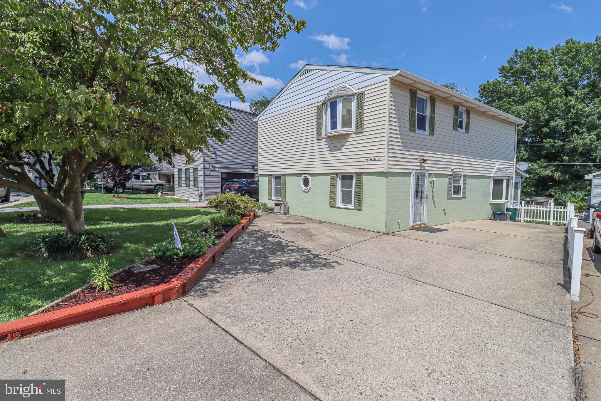 Back on the market! Spacious Colonial Style Home with a Large Fenced-In Yard and water views on Bullneck Creek in Dundalk, Baltimore County. The home includes 2,128± total square feet, 4 bedrooms, 2 full baths, and a lower level, situated on a private 0.24± acre lot. The main level features a large galley kitchen, dining room, family room with built-in solid oak shelving and a bow window, office with desk and cabinets, a spacious sun room and a full bath. The upper floor includes four large bedrooms and a full bath along with a storage closet with shelves. The primary bedroom includes a large closet with additional storage area and a bow window.  The lower level of the home is finished and includes a large recreation room, workshop area, storage/utility room, and a laundry room. The main level has a walk-out to a rear patio. Features include 2 large sheds out back with lots of deck space for entertaining or family gatherings. Stroll down to the water where you will find a bulkhead, lots of potential and very pretty views. This home offers plenty of parking and is located in a quiet neighborhood. Major components such as the roof, HVAC, hot water baseboard boiler have gotten upgrades. Pride of ownership is evident.