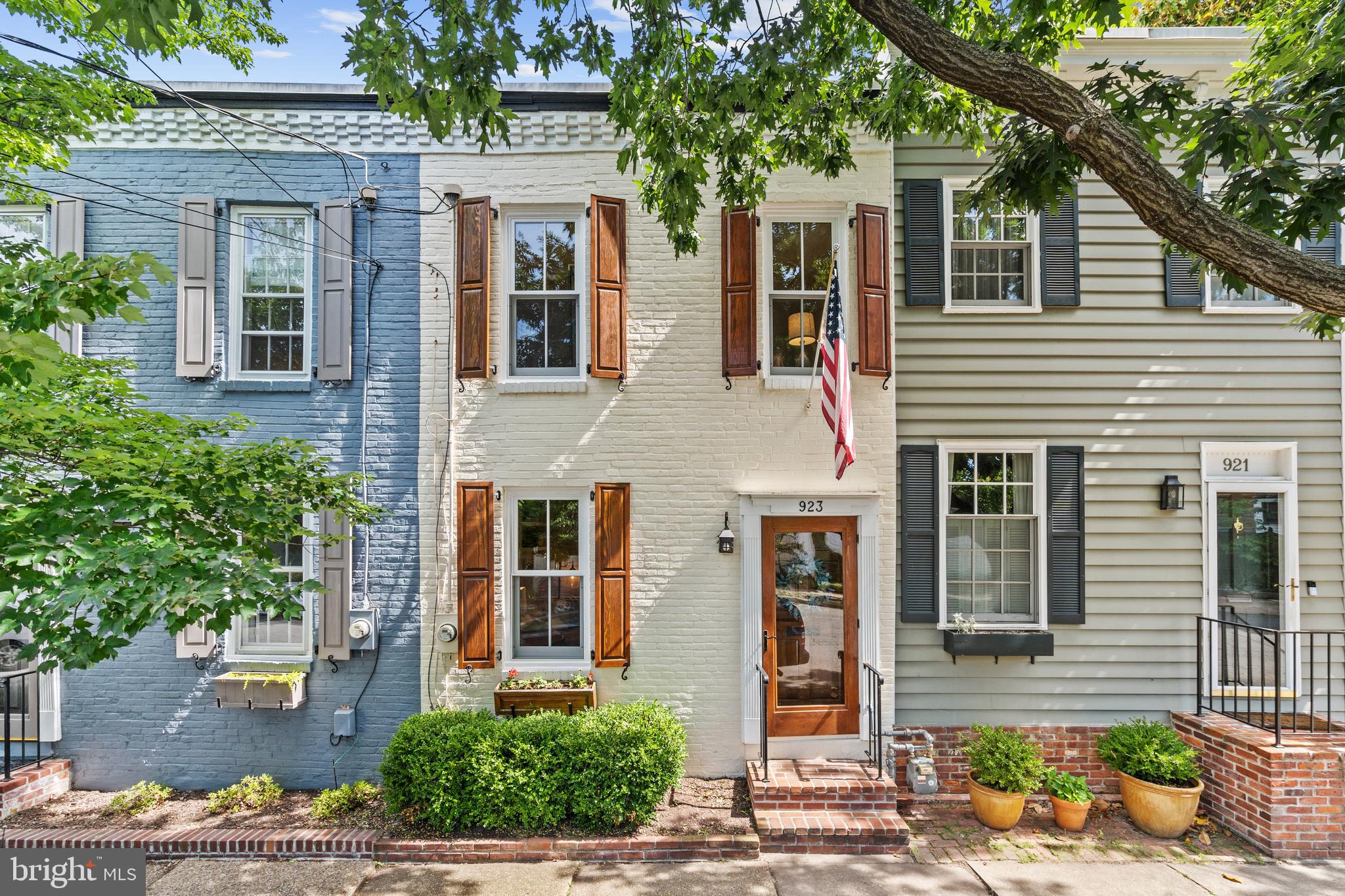 Nestled in the heart of historic Old Town Alexandria, 923 Oronoco St seamlessly blends classic charm with modern sophistication. This stunning residence boasts exquisite architectural details, from its timeless brick façade to the beautifully appointed interiors. Sun-drenched living spaces, high ceilings, and gleaming hardwood floors create an inviting ambiance, while the gourmet kitchen, complete with premium appliances and elegant finishes, is a chef’s delight. This gorgeous kitchen was expertly renovated by Marks Woods Construction, an award winning, local design firm. This home also boasts the most charming half bathroom on the main level and a large entryway closet, which are atypical for many of these turn of the century homes.

Upstairs, spacious bedrooms provide a serene retreat, complemented by a spa-inspired bathroom designed for relaxation. Don’t miss the custom shelving in the large walk-in closet in the primary bedroom and the custom armoire. The upstairs skylight drenches the upstairs hallway with so much natural light and features exposed beams. 

The private outdoor space is perfect for entertaining or unwinding in a tranquil setting. The rear yard is fenced in and has plenty of space to start that garden that you have always been dreaming about.  The beautifully appointed landscaping and lovely tree are such a nice feature of this home.  A newly laid paver parking pad, accessible through the garden gate, also provides the convenience of private off-street parking. 
Situated just moments from King Street’s renowned shops and restaurants, waterfront parks, and convenient transit options, this exceptional home offers the perfect balance of luxury and location. You are just a short stroll away from the King St Metro Station and Amtrak train station. 
Experience the best of Old Town living at 923 Oronoco St—where historic charm meets contemporary elegance. 

Updates include a renovated kitchen with Braemar Cabinetry and Bosch appliances, renovated bathrooms, new paint throughout most of the home, new double-pane windows, a newer HVAC system, a new water heater, new washer and dryer, and a newer parking pad.