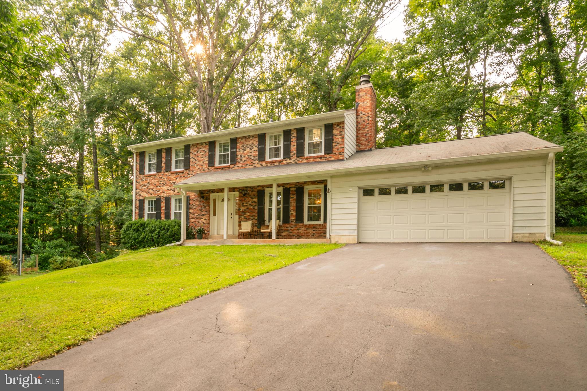 Welcome to 13402 Carrageen Ct.! Nestled on a private cul-de-sac lot of over an acre, this spacious home offers five rooms and two full bathrooms on the upper level, hardwood floors throughout the main and upper levels, and no HOA. The main level features a cozy fireplace, while the fully finished walkout basement includes a second fireplace, a full bathroom, and access to the expansive backyard via the walkout slider.  Enjoy outdoor living from the welcoming front porch or the rear deck, and take advantage of the oversized garage for additional storage and parking. Conveniently located near shopping, restaurants, commuter routes, and a new Publix under construction.  This dreamy home is zoned for Colgan High School, Benton Middle, and Coles Elementary.