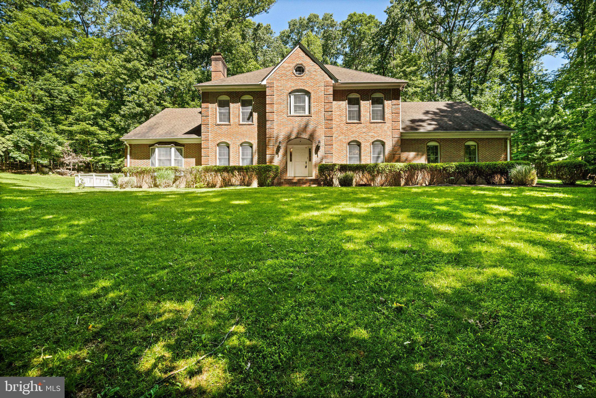 Nestled on five private, wooded acres in Great Falls, this charming 4-bedroom, 3.5-bath home offers the perfect blend of space, character, and tranquility. The main level features a stunning wood-paneled library with custom built-ins, ideal for a home office or cozy retreat, along with two sun-filled sunrooms that provide peaceful views of the surrounding landscape. Upstairs, the spacious primary suite serves as a sanctuary, complete with a private sitting room, fireplace, and generous walk-in closets. Surrounded by mature trees and natural beauty, this property offers a rare opportunity to enjoy privacy and serenity while remaining close to everything Great Falls has to offer.
