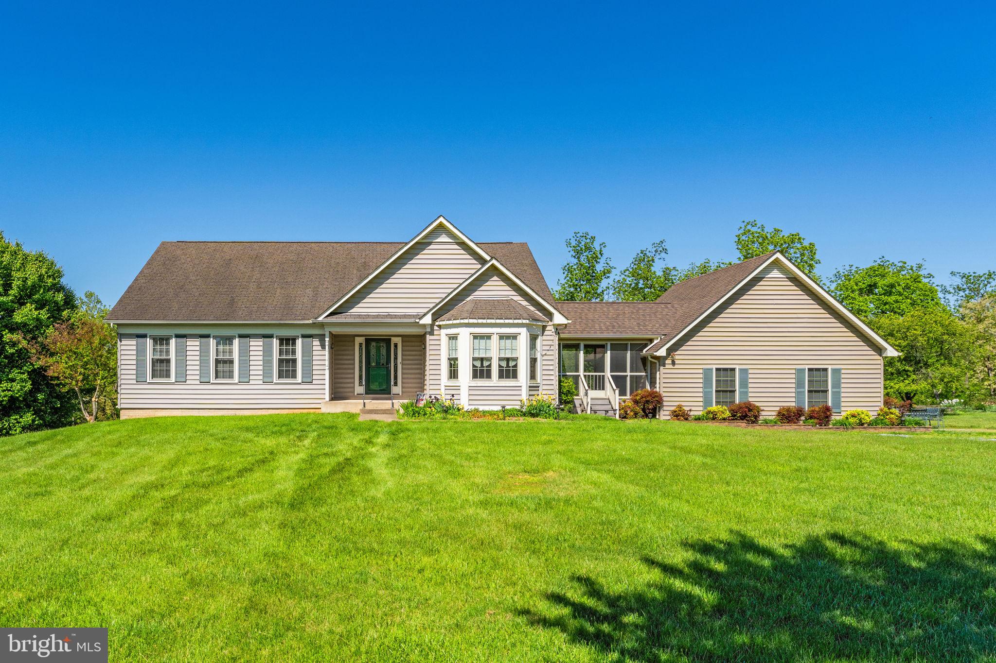 Don’t wait to come take a look at this large custom- built home situated in the middle of 17 open and useable acres!  Surrounded by mountain and rolling pasture views, this home awaits a new owner to tend the flower gardens and koi pond. 
 You'll feel like you're miles away from the city, but in reality, you aren't far from the convenient shopping, grocery stores, schools, & restaurants in nearby Purcellville. Hop on Rt. 7, head West to the Appalachian Trail for hiking, or go up on the mountain to a winery or brewery.  Head East on Rt. 7 for fine dining and shopping in Leesburg. Great location!
Convenient main-level living plus a fully finished lower level that has the potential for an in-law suite, nanny quarters, or additional income as a separate apartment. 
Stone pillars on either side of the driveway lead to the circle in front of the home and the side-load attached garage.  A large shed for your mowers & equipment conveys to purchasers. There is also a storage loft in the garage with pull-down stairs for access. 
The Breezeway between the kitchen and garage has its own front entrance. It is screened-in, has a fan, and makes a great spot to enjoy your morning coffee, rain or shine.
Enjoy the light-filled Kitchen open to the Living Room.  The Kitchen has lots of cherry cabinets, and wood floors. The appliances include a refrigerator with icemaker, dishwasher, microwave, disposal and gas stove.
The heating system is also fueled by propane gas. 
Overlooking the front lawn is the Dining Room area with a large bay window.
The spacious Living Room has oak wood flooring, and a gas fireplace. French doors lead to the deck.
Wonderful large deck off the main level is great for entertaining, plus there’s a flagstone patio on the lower level if you are having a festive party. Part of the deck is covered by an attached gazebo with a fan.
Large main level Primary Suite with lots of closet space and a luxurious bath with a jacuzzi tub. An additional Bedroom #2, a Hall Bath and a conveniently located Laundry Room complete the main level.
The walkout lower level has lots of lighting and a full Kitchen, plus abundant closet space and storage. A large Family Room with a second gas fireplace has doors leading to the stone patio, 
There are two additional Bedrooms #3 and #4 and a 3rd Full Bath in the lower level as well.  
A water purification system, tankless water heater and generator have all been added for additional comfort. 
Enjoy the peaceful surroundings and the professionally landscaped lot. Extensive hardscaping including a patio with a path leading to a stone wall garden and koi pond. There is beautifully manicured front lawn with flowering trees, shrub and perennial flowers,
 Four board fencing along the front along with stone pillars at the entrance. An old stone wall is on the lot line on one side. The Plat is located in the 'documents" section.
This property has been in land use so there’s tax savings if agricultural use is continued with the new owners. Seller will not be responsible for roll-back taxes. Currently there is a cattle farmer leasing part of the 17 acres. The land is also very suitable for horses, sheep or whatever you’d like to enjoy and use it for.