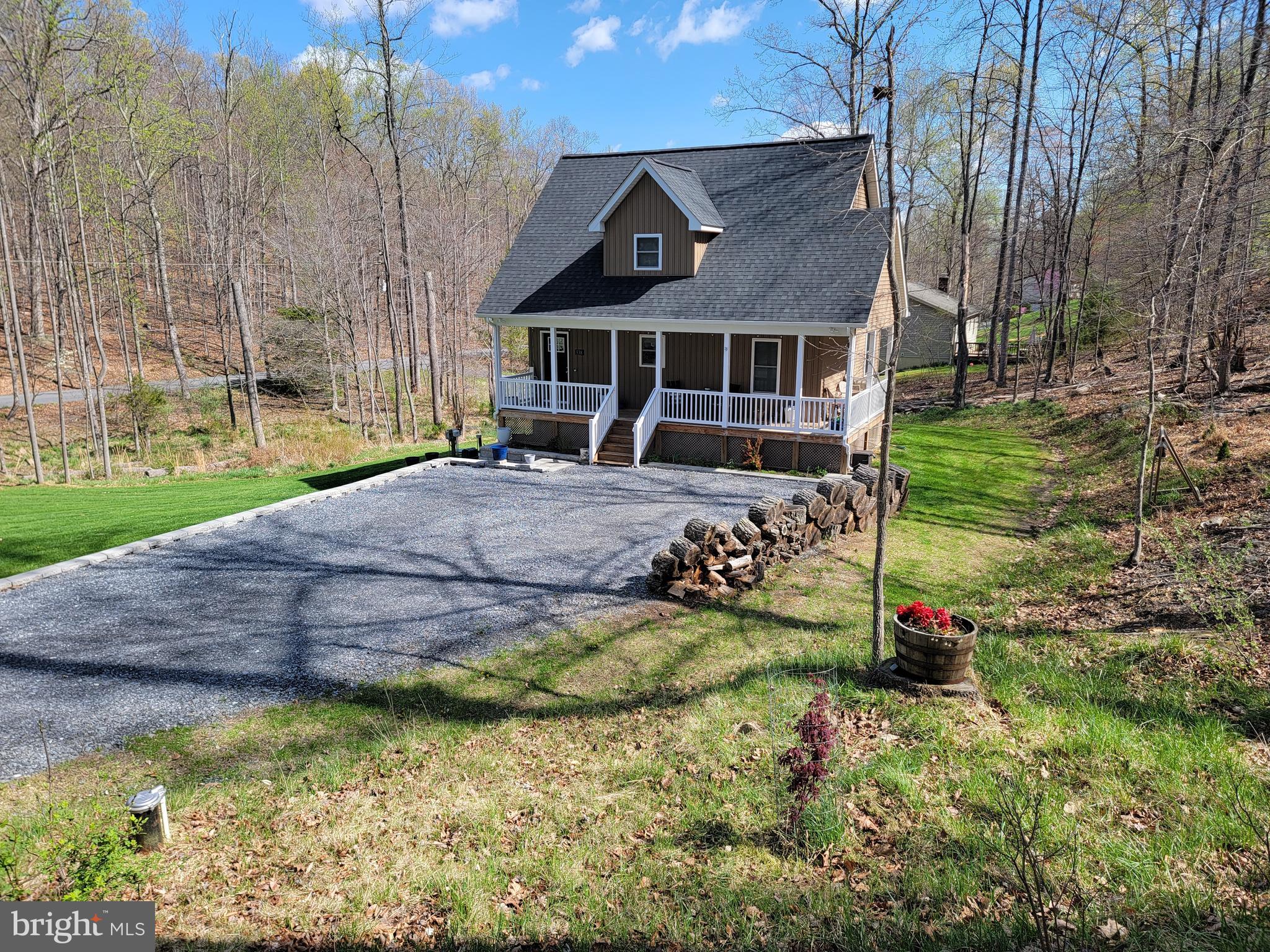 Beautiful Cape Cod Style only 3 years old.  One acre lot at bottom of Apple Mountain Lake. No steep Hills to worry about.  Covered  Wrap around Porch, 3 levels with unfinished walk out basement.  Also outside patio from basement and shed.  3 bedrooms and 2.5 Baths with a rough in for a future bath in the basement. There is a main level master bedroom with private bath.  Home shows very well and Owners have done a lot in 3 years.  It is very cozy.  Listing agent is related to the Seller. Septic = # bedrooms, alternative field.  Appointment only call first.  Ring Cameras Present on Property.
