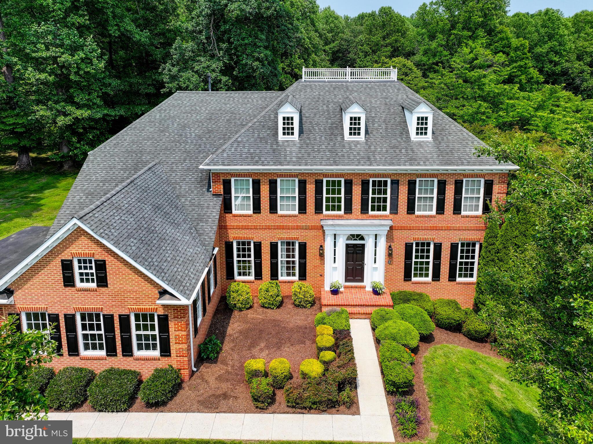 Open house canceled !Stately brick-front NV Home on a premium .96-acre lot in sought-after Brantwood, located at the end of a no-through street and siding to wooded parkland with Manor Woods Elementary just beyond. This one checks every box—location, layout, and luxury! The owner is an accomplished, award-winning decorator, and the home beautifully reflects her exceptional eye for design with tasteful upgrades and custom touches throughout all three finished levels. Inside, you'll find updated flooring, designer lighting, chic paint selections, detailed millwork, and a renovated gourmet kitchen featuring quartz countertops, a gorgeous marble backsplash, painted cabinetry, stainless appliances, a walk-in pantry, a center island, and a back staircase leads to the upper level, adding function and flow. The kitchen opens to a large breakfast area and a stunning sunroom, both with walls of windows offering tranquil views of trees and open lawn. The main level wows with a dramatic 2-story foyer with curved staircase, an elegant formal dining room, a library with wall of custom built-in lighted cabinetry and coffered ceiling, a private office with custom built-in, a spacious updated powder room, an inviting family room with built-ins, wall of windows. a gas fireplace with updated custom surround, and a full-size laundry/mudroom with built-ins and convenient sink. Upstairs, the luxurious primary suite offers a sitting area, tray ceiling, dressing area with dual walk-in closets, and an updated spa-inspired bath with freestanding tub, oversized walk-in shower, double vanities, and gorgeous decorator tile. Three additional spacious bedrooms include one with an updated private en-suite and two with a Jack & Jill layout. The walkout lower level is bright and versatile, featuring a rec room, media room, 5th bedroom/exercise room, full bath, built-in wet bar, storage room, hobby/playroom with cabinetry and sink, plus great storage. Outdoor living shines with a maintenance-free tiered deck with a gas line installed for a BBQ grill, manicured yard, and charming treehouse. The oversized 3-car garage includes epoxy floors, and 5 full-sized windows provide plenty of natural light. This is a rare opportunity to own a one-of-a-kind showplace in Brantwood—privacy, luxury, and location all in one! Don’t wait—homes like this don’t come around often!