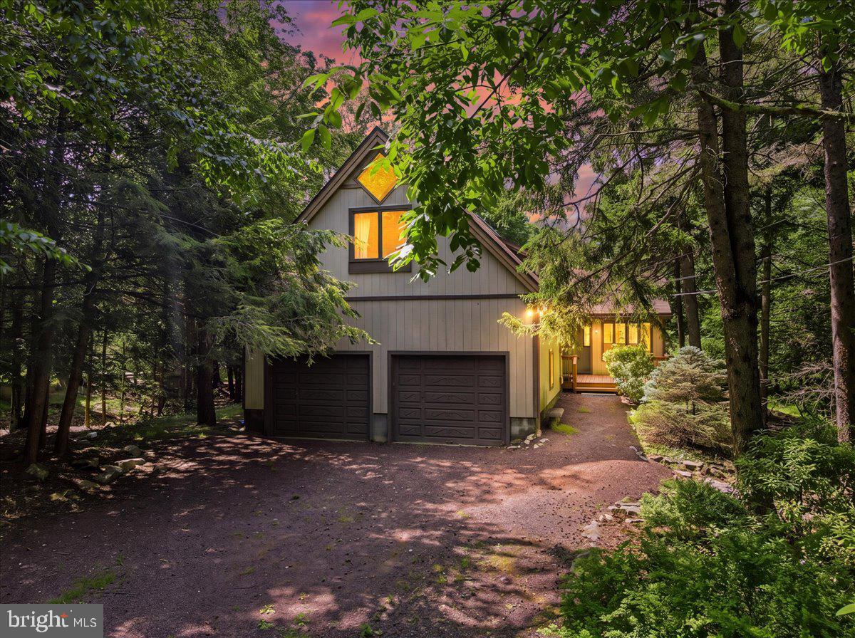 From the moment you arrive, you'll feel it—this home is truly something special. A peaceful waterfront retreat where thoughtful renovation meets timeless mountain charm, this fully renovated home offers a rare opportunity in the highly sought-after Lake Naomi community. Nestled along the serene Upper Tunkhannock Creek with protected green space, the property offers privacy, tranquil water views, and a sense of peace that immediately feels like home. Ideally located within walking distance to Lake Naomi, the Clubhouse, the Main Pool and beach, this home puts the best of the community right at your doorstep.Inside, classic Pocono character blends seamlessly with modern comfort. Soaring cathedral ceilings, abundant natural light, and an inviting open-concept kitchen, dining, and living area create a warm gathering space perfect for everyday living and entertaining. The renovated kitchen features a large island, quartz countertops, stainless steel appliances, and a stylish tile backsplash. The adjoining living room with a cozy gas fireplace opens to a four-season room showcasing peaceful creek views and the beauty of every season.The first-floor primary suite offers convenient single-level living with a walk-in closet, deck access, and a spa-inspired bath featuring a tiled walk-in shower, freestanding soaking tub, and elegant finishes. Upstairs provides two additional bedrooms, a full bath, and a versatile bonus room ideal for a family room, office, game room, or potential fourth bedroom.  Recent renovations include central air conditioning and forced propane heat for year-round comfort. Multiple outdoor living spaces invite you to enjoy the sounds of the running creek, while the oversized two-car garage offers excellent storage and the potential for a future game room, home gym, or recreational space.Located in the prestigious Lake Naomi Club, a Platinum Club community, enjoy exceptional amenities including lakes, beaches, pools, tennis, pickleball, fitness, golf, clubhouse dining, sailing, and year-round recreation. Conveniently located near New York City, Northern New Jersey, and Philadelphia, this home provides the perfect balance of accessibility and escape—close to everything the Pocono Mountains are known and loved for, yet tucked away in your own private creekside retreat.  A rare opportunity to own a truly special property where every season brings a new reason to stay.