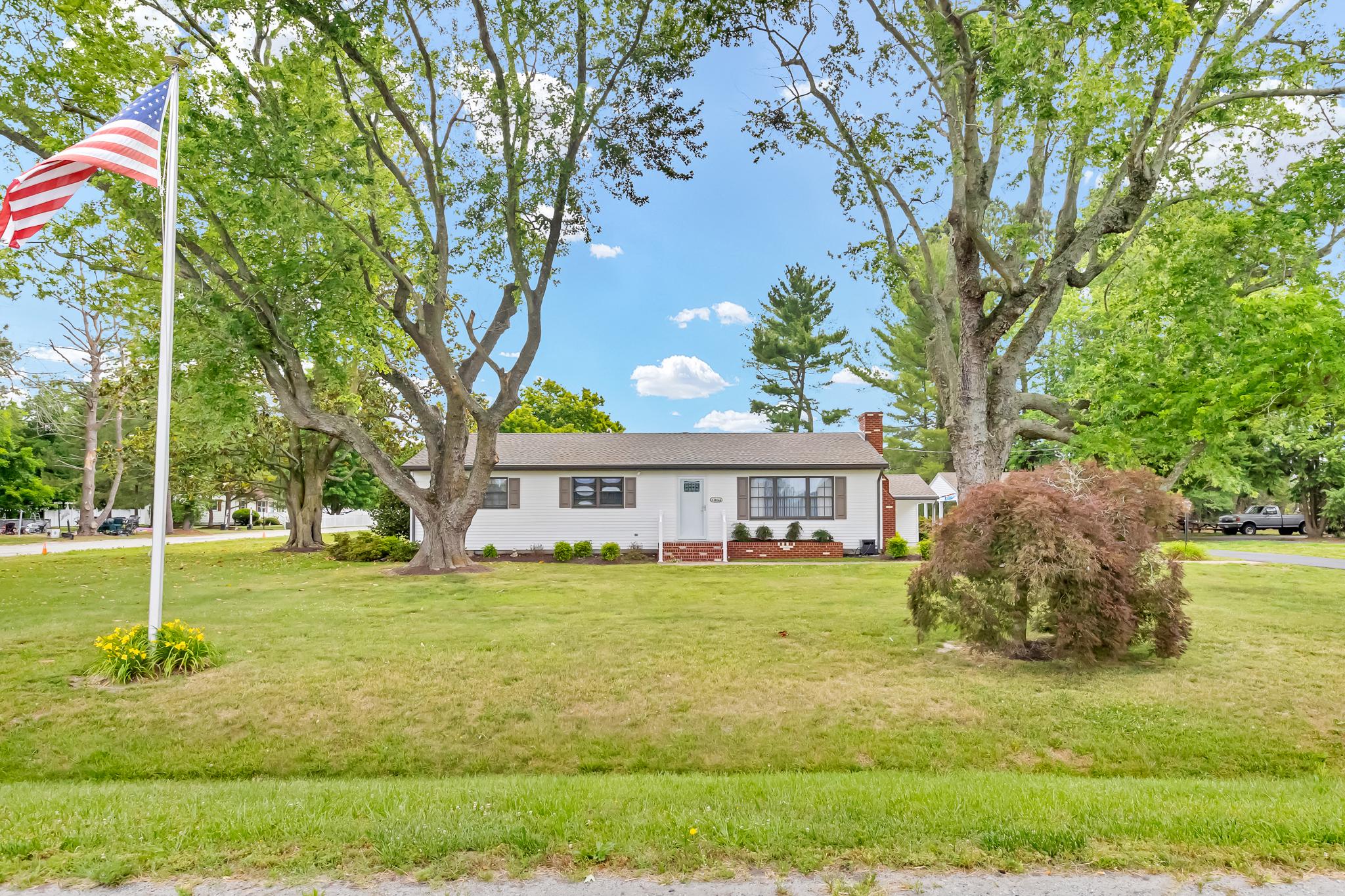 Welcome to your dream sanctuary! This meticulously maintained home offers a perfect blend of indoor comfort and outdoor paradise, situated on a spacious lot that’s ready to accommodate all your lifestyle needs.

As you arrive, you’ll be greeted by a paved driveway providing ample parking options, including a one-car carport attached to a workshop, a freestanding carport, and plenty of room to park in the driveway itself. The property features a pole barn: one side boasts a "regular" garage door and concrete floor, while the other side remains unfinished with a sliding barn-style door, offering generous clearance for storing boats or other large items. There is an additional storage shed beside the pole barn. Both buildings have electric, and there is a hose spicket in between the buildings for convienence. 

The yard is truly expansive with mature landscape and a blank canvas for your gardening dreams, outdoor oasis, or entertaining space.

Inside, you’ll find a warm and inviting layout featuring four bedrooms and two remodeled bathrooms. Gorgeous original hardwood floors flow throughout the majority of the home, exuding character and charm. The living room and den both showcase stunning wood beams and cozy fireplaces, creating ideal spots for gatherings or quiet evenings at home.

The kitchen is highlighted by new quartz countertops paired with original real wood cabinetry, blending modern convenience with classic style. Additionally, a serene four-season room off the den, complete with a ductless AC unit, provides the perfect space to unwind while enjoying the beauty of every season.

This incredible home has been lovingly cared for by just one owner, making it an exceptional find in today’s market. Don’t miss your chance to claim this gem and create lasting memories in a space that truly feels like home!