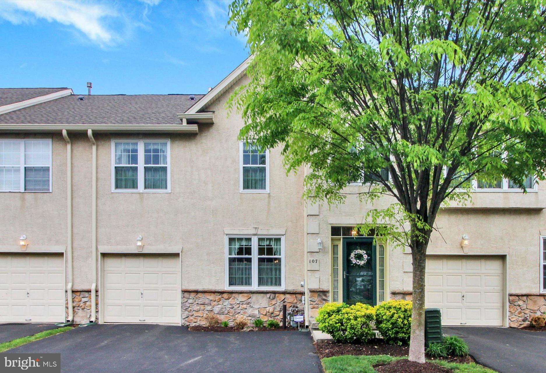 Presenting 107 Castle Drive in the desirable Hampton Green community of Montgomery Township. Pride of ownership is evident as soon as you step into this charming townhouse, meticulously maintained by the original owner. Warm, wide-plank hardwood floors span the living and dining rooms and continue into the stunning two-story family room. Here, you’ll appreciate the expansive feel created by the high ceiling and 2nd story overlook, as well as the natural light. A gas fireplace is the focal point of the room, and is just the place to curl up on chilly winter nights. The family room opens onto the eat-in kitchen with ceramic tile flooring, where plentiful counterspace makes meal preparation a breeze. Upgraded high cabinets and a separate pantry afford ample storage. A center island with seating provides additional counterspace and serves as a spot for a quick bite or a gathering place while entertaining. The breakfast area overlooks the expanded deck, the perfect setting to enjoy your morning coffee, a glass of wine, or al fresco dining. The ceramic tile floor flows from the kitchen into the powder room and mudroom with garage access to round out the main level.
A wooden staircase leads the way from the living room up to the second floor, where wood floors continue throughout the hallway and bedrooms. As you reach the top of the stairs, take a moment to admire the view of the family room from the overlook before heading down the hall towards the double doors to the spacious primary suite, your retreat at the end of the day. The ensuite bathroom boasts a dual vanity, a soaking tub and stall shower, as well as a separate linen closet. There is a large walk-in closet in the bedroom.
The two good-sized guest bedrooms share a hall bath with dual vanity and tub/shower combo. For your convenience the large laundry room with utility sink is located on this level – no more hauling laundry baskets up and down the stairs! 
The full, unfinished basement houses mechanicals and is currently used for storage.
The homeowner has made many updates in recent years, including the flooring, stove and dishwasher. There is a newer front door; the rear slider and all windows were replaced in 2015. For your comfort and peace of mind, the roof, HVAC and hot water heater were all replaced in 2024; a new alarm system was recently installed; and there is a battery back-up for the sump pump.
Located within in the highly rated North Penn School District, Hampton Green community is conveniently situated, with easy access to Rts 309, 202 and the PA turnpike. Nearby Montgomeryville Mall and other shopping hubs are minutes away. You’ll want to see this one for yourself – schedule a tour today!
(Some photos have been digitally modified to remove personal objects.)