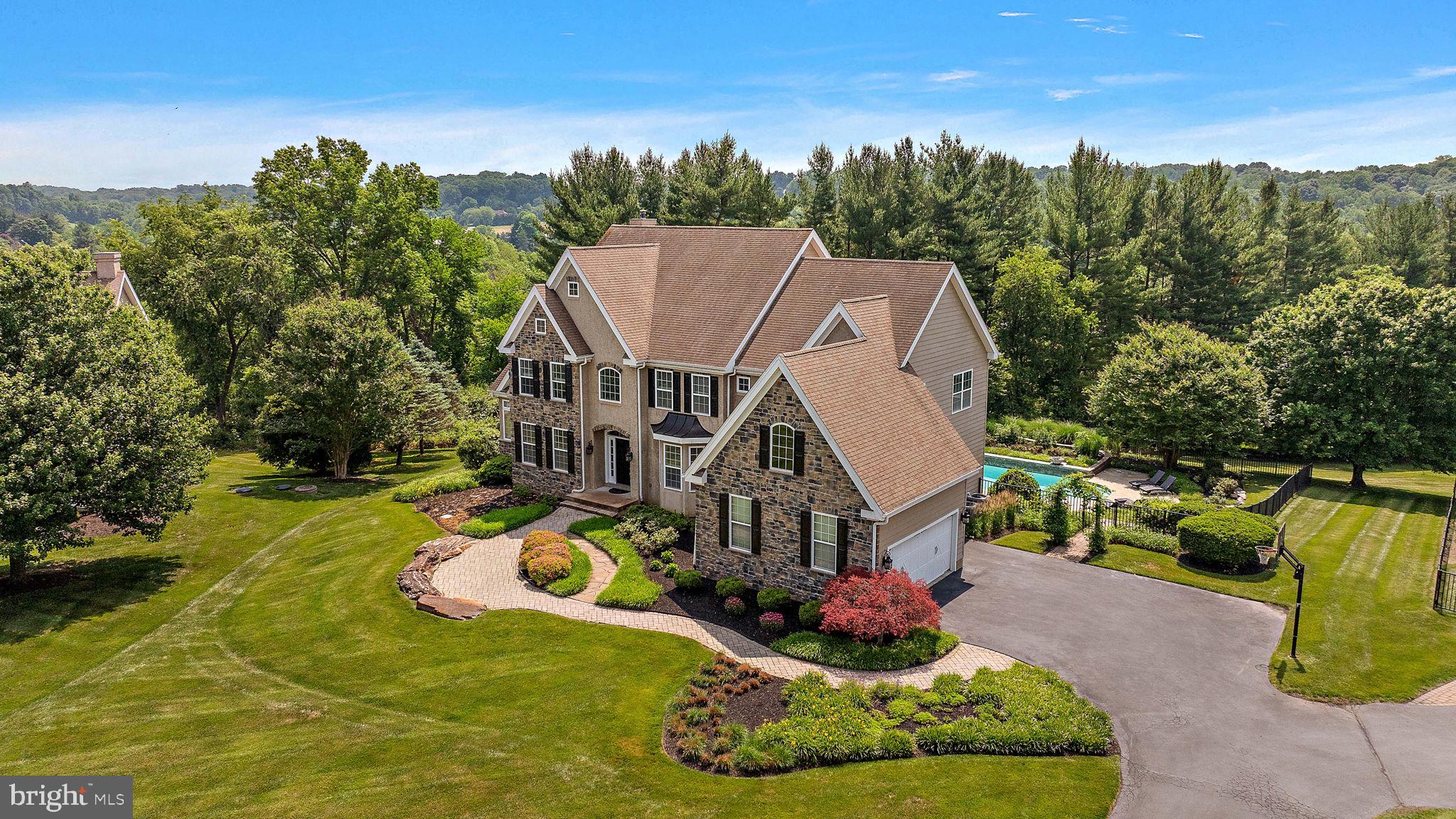 This exceptional residence offers an ideal blend of timeless design, thoughtful updates, and resort-style outdoor living. A grand two-story foyer sets the tone and opens to elegant formal living and dining spaces highlighted by hardwood flooring, detailed millwork, and classic architectural finishes. A private first-floor office provides the perfect work-from-home environment.  Designed for both everyday living and entertaining, the heart of the home features a spacious family room and adjoining conservatory connected by a striking two-sided fireplace. The gourmet kitchen is beautifully appointed with granite countertops, custom tile backsplash, stainless steel appliances, a farmhouse sink, and abundant cabinetry.  The second level is anchored by an impressive primary suite complete with a private sitting area, generous walk-in closet, and a luxurious en-suite bath featuring a soaking tub, oversized tile shower, and dual granite vanity. Three additional bedrooms, two full bathrooms, and a convenient second-floor laundry room complete the upper level.  The finished walkout lower level significantly expands the living space and includes a guest bedroom, full bathroom, media and recreation areas, and a custom bar ideal for entertaining. French doors lead directly to a covered paver patio overlooking the private backyard retreat. The beautifully landscaped outdoor setting is highlighted by an in-ground pool, creating the perfect space for relaxation and gatherings throughout the year.  Significant recent improvements include the replacement of stucco with durable Hardie board siding and the installation providing peace of mind for years to come. Meticulously maintained and thoughtfully updated, this is a rare opportunity to own a truly turnkey home in an exceptional setting.  Welcome Home.