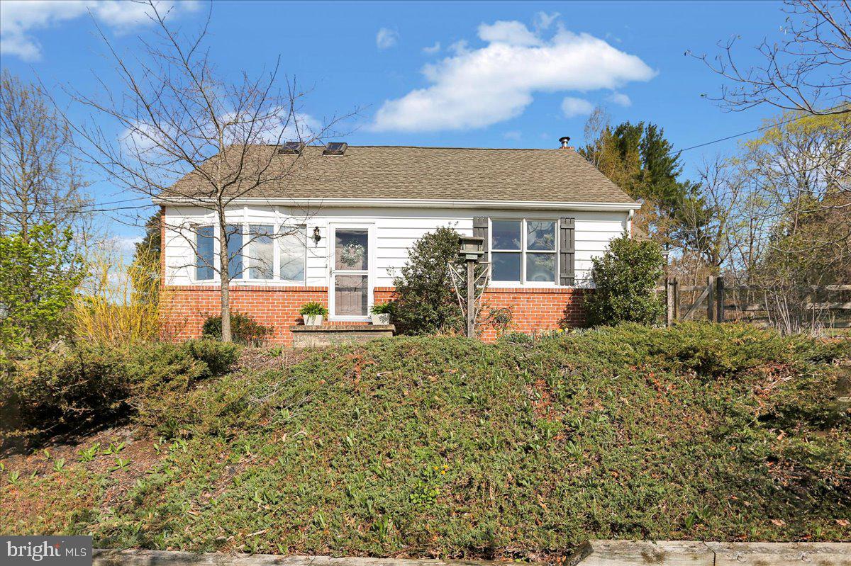 Highest and Best offers due by Thursday April 17 by 8am.  Welcome to this extremely well-maintained property with tons of character and amazing views, located less than 2 minutes to Rt 222.  This cape cod offers hardwood floors throughout and bay windows from the living room and dining room that provide views for miles.   The living room has wood ceiling beams and a built-in cabinet, as does the dining room, which flows seamlessly into the kitchen.  The mudroom/laundry room is conveniently located off the kitchen.  There is a first-floor bedroom and full bath.  Upstairs is the primary bedroom with a vaulted ceiling and skylights and the 3rd bedroom that also has a vaulted ceiling, and another full bath.  The finished lower level offers a family room with a wood stove, which is the primary heart source for these owners, and a bonus room with a built-in desk and workstation…whether you use this space as an in-home office, hobby room or homeschooling, you have plenty of workspace!  There is a one car attached garage with a small storage room in the back.  We’re just getting started…because the real party is outside! There are 3 outbuildings; a woodshed that is conveniently located off the driveway to store your firewood, a large garden shed and a custom-built barn complete with electric and heat located at the back of the property, a great place for a barn party!  The fully fenced-in backyard offers a 2 tiered deck and patio and a pergola with a swing and the mature landscaping gives this property eye-catching curb appeal. In addition to the new vinyl siding in 2018, this home offers all vinyl replacement windows a 10 year old roof and a radon remediation system. and a central vac.   This home is truly move in ready!
