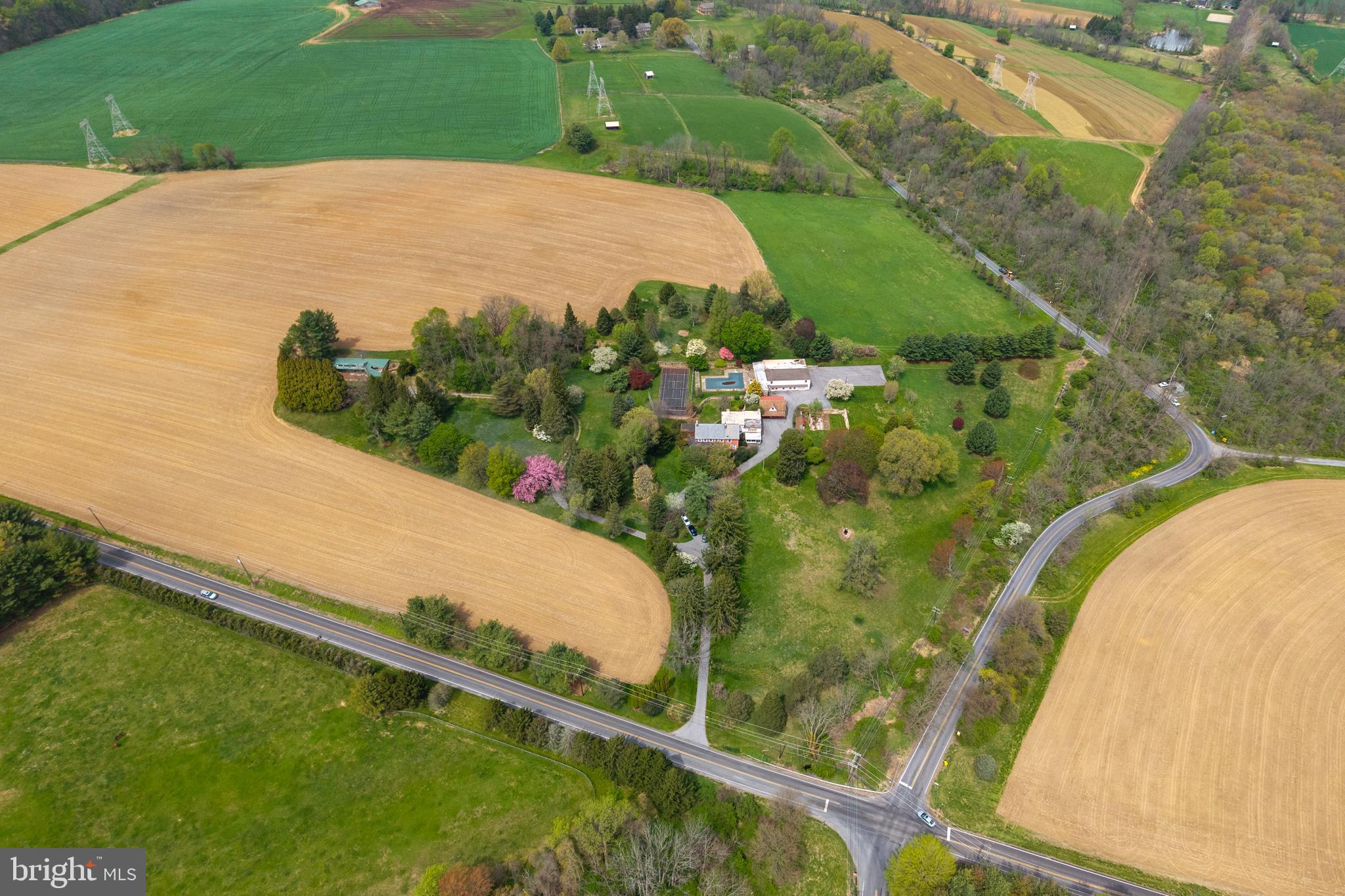 Just on the market, an interesting Chester County farmhouse and 69+ acre prized farm property.

In Cheshire Hunt country this 4 BR, 2 bath centuries old farmhouse has great bones and a number of dilapidated additions, the latest of which is from 1967 (6,804 SqFt above grade with central air and hot water heating). 

The house could be a partial rehab project, saving the original, or a tear down. 
The property, well off the road, has beautiful specimen trees and is nestled in a warm, sunny spot on the south side of the hill, well protected from northern winter winds, as was the norm for many old farmsteads in Chester County.

There is a lot of garage space with loft, storage or office space above. Pool house with screened-in porch attached to the large garage. Pool and tennis court need upgrading. Old unfinished apartment in a separate building with garage space, can be refinished or raised. Another garage area/shed near the house and still another shed near the old barn ruins.

Located in West Marlborough Township in the Unionville-Chadds Ford School District, this is an agricultural gem that is under Act 319 and also in the Chester County Agricultural Program. The property may not be subdivided. Property is priced to move!
Being sold "as is, where is"