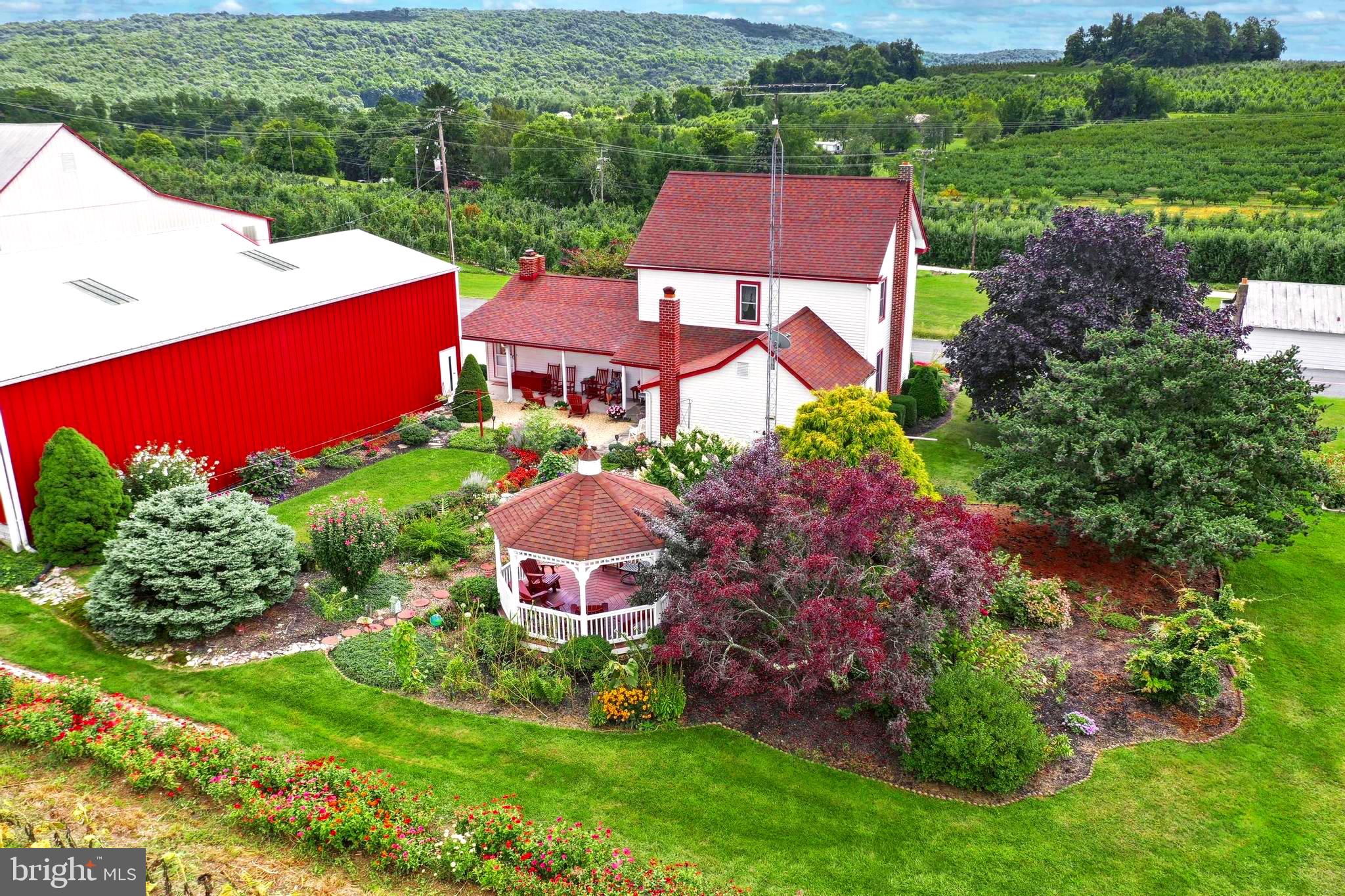 24.11 Acres featuring 2 Houses!  OWNER FINANCING AVAILABLE FOR QUALIFED BUYERS!  (with a great interest rate). Farm includes a  2744 sq.ft. farm house featuring 3 bedrooms, 1.5 bath, eat in kitchen, sunroom, formal dining room, hardwood flooring, living room, huge family room with brick fireplace,  and first floor laundry room.  Home offers a full basement, with workshop, walk up attic, and new electric panel.  Exterior offers front and rear covered porches, gazebo, mature gardens and detached 2 car garage.   2nd house on property is a 1 bedroom rancher (could be 2) with an eat in kitchen, large living room, first floor laundry and a 2  attached car garage.  Farm offers a 30x60 Morton building, cold storage, barn, machine shed, additional outbuildings, and black top driveways.   
Property has residential well 100' and an irrigation well 400',  2 septics with back up sites, 200 amp service and 3 phase on site.    Retired Peach orchard will be removed.