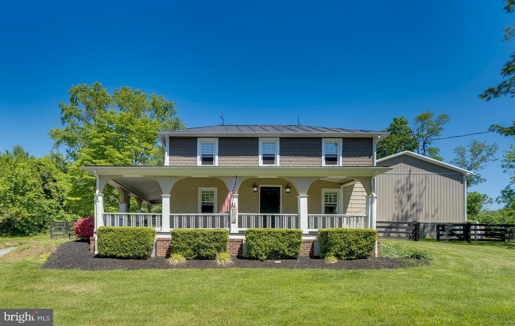 Immaculate 1920’s home with a large barn, brimming with timeless character and modern luxury. This one-of-a-kind property offers an exceptional lifestyle with a 30’x50’ barn in the heart of Purcellville. The beautifully renovated Southern charmer offers 3 bedrooms, 2.5 baths, and 1,798 square feet, thoughtfully updated while preserving its historic appeal. A welcoming wraparound front porch sets the tone, perfect for relaxing and enjoying the peaceful surroundings. The open floor plan is enhanced by engineered hardwood floors, exposed beam ceilings, and abundant natural light throughout, which flows seamlessly into the living and dining rooms, creating an ideal space for both everyday living and entertaining. The gourmet kitchen has been tastefully updated with high-end finishes, custom tiled backsplash, stainless steel appliances, and bar stool seating option. Upper level features a spacious owner’s suite that provides a private retreat with vaulted ceilings, plush carpeting, and a custom walk-in closet. Additional bedrooms are well-appointed and offer flexibility for guests, family, or a home office. Unfinished lower-level basement includes a laundry room and flexible space for storage, a workshop, or future customization.  The fully electric-outfitted barn includes two splits and is temperature-controlled for summer and winter. With this large 0.73-acre lot, there's plenty of space for outdoor fun and activities, with a large patio, retaining wall, and fire pit, all within a fully fenced backyard designed for both relaxation and entertaining. The circular driveway has an electric gate for added convenience and privacy. With its rare blend of historic charm, modern upgrades, and prime location near shops, dining, and top-rated schools. Ideally located in the heart of Old Town Purcellville.