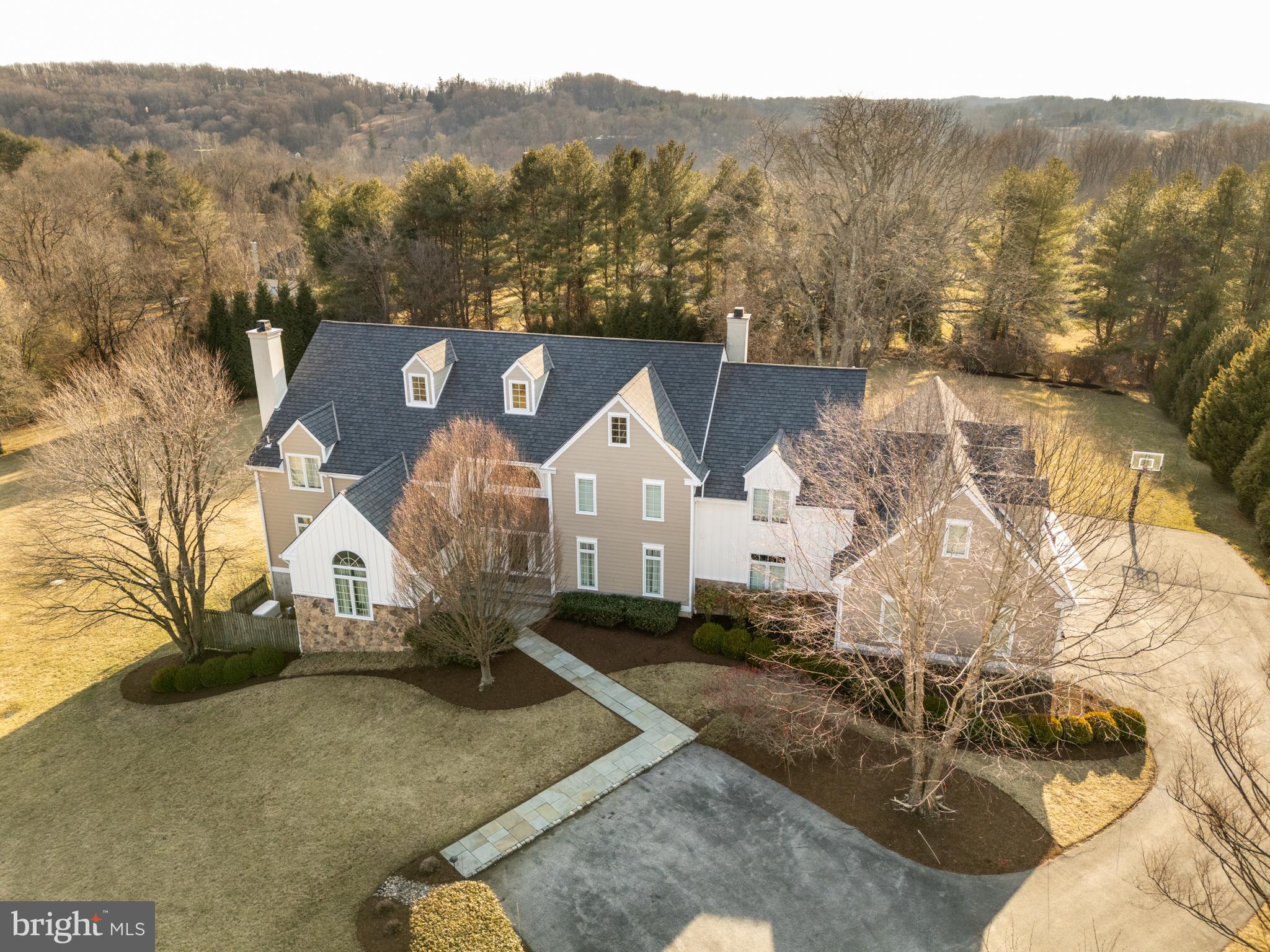 Nestled in the exclusive Birmingham Estates, this breathtaking five-bedroom, four-full and four-half-bathroom home is the epitome of refined living. Set on 3.5 private acres, this hilltop estate offers stunning views, an exceptional layout, and a backyard retreat—all within minutes of West Chester’s vibrant downtown, scenic trails, and top-rated schools.

A grand stone-pillared entrance and winding driveway set the stage for this magnificent home. Inside, a three-story atrium-style staircase welcomes you with soaring ceilings, gleaming hardwood floors, and abundant natural light. Designed for seamless entertaining and everyday comfort, the open-concept layout flows effortlessly from one elegant space to the next. The grand two-story family room features vaulted ceilings and custom built-ins, while the formal living room boasts an inviting fireplace. A sun-drenched sitting room provides another peaceful space to unwind. The heart of the home is the designer chef’s kitchen, a true showstopper with custom cherry cabinetry, premium granite countertops, Wolf and Sub-Zero appliances, and an oversized island. A cozy fireplace and stainless accents add warmth, while the kitchen opens to a sunroom, dining area, and an expansive outdoor patio. Two private home offices offer inspiring views and a quiet setting for remote work.

The second floor is anchored by the luxurious primary suite, a private retreat featuring a spacious sitting area, a spa-like bath with a walk-in shower, and an oversized walk-in closet with a center island. Two additional bedrooms share a beautifully designed Jack-and-Jill bath, while a third guest suite offers a private en-suite. A bright fifth bedroom and a convenient second-floor laundry room complete this level.

The finished third floor offers endless possibilities, making it an ideal space for a home office, yoga studio, or creative retreat.

The lower level is an entertainer’s dream. The finished walkout basement includes a guest suite, a billiards area, a media space, and direct access to the backyard.

The outdoor living space is just as impressive as the interior, with an expansive stone patio, a covered pergola, and a built-in grilling station, all surrounded by beautifully manicured gardens and mature trees. Whether hosting a summer barbecue or enjoying a quiet evening under the stars, this outdoor retreat is truly exceptional. A three-car garage and a driveway basketball hoop add both practicality and fun to an active lifestyle.

With recent high-end updates, including Hardie Board siding in 2021, a new roof in 2018, and updated windows and doors in 2010, this home is move-in ready and built to last. Located in the heart of Wyeth Brandywine country, just minutes from Longwood Gardens, Radley Run Country Club, and downtown West Chester, this home offers the perfect balance of serenity and convenience.

Don’t miss this rare opportunity—schedule your private tour today!