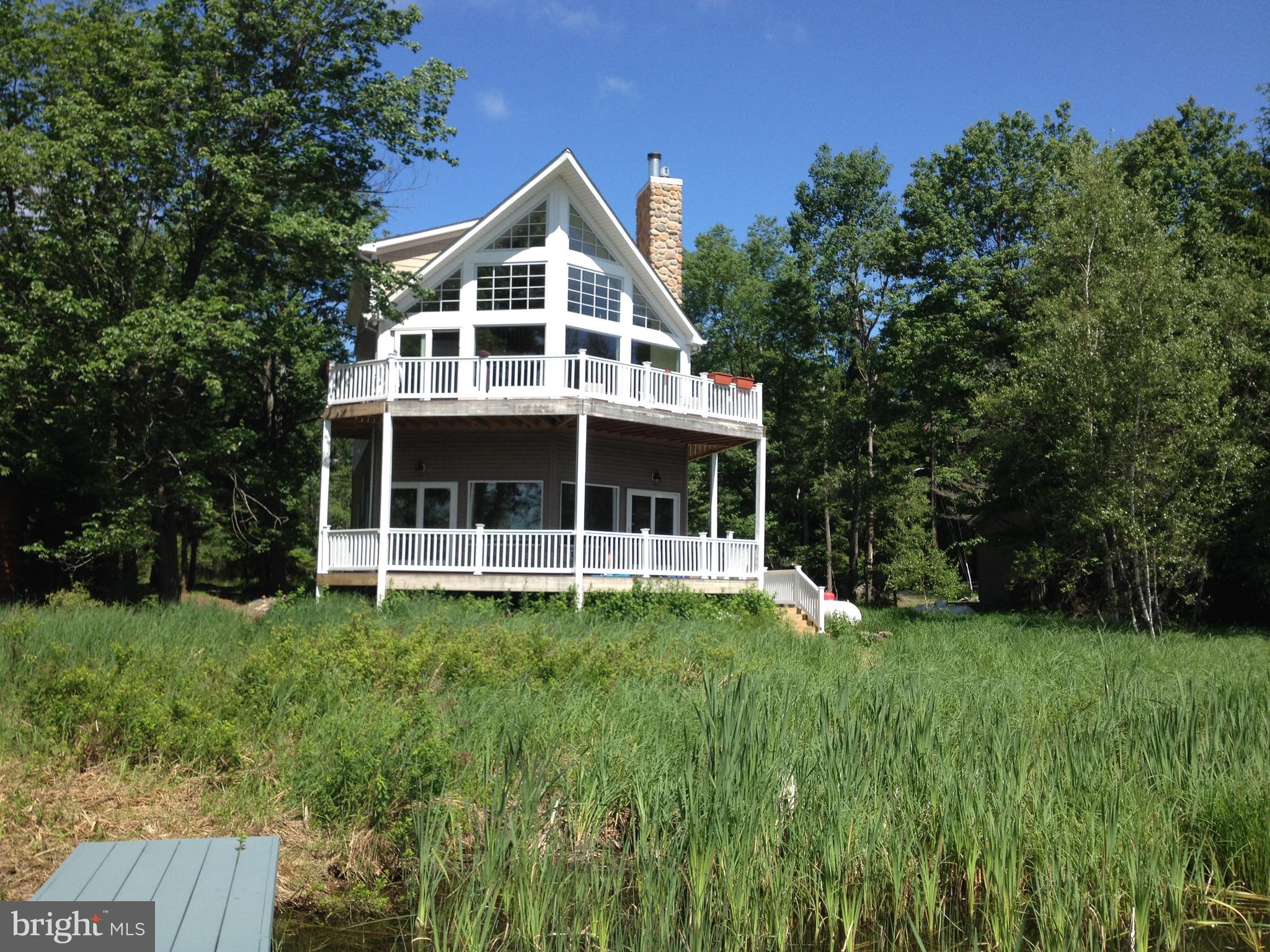 Lakefront living in a gated year round community.  **Have a large family or love to entertain?  Stunning lakefront home offers all the space and comfort you may need.  Upgraded features includes, 5 spacious bedrooms, 4 1/2 bath, expansive family room, 2 decks overlooking the large lake.  Central A/C and gas heat, whole home generator, beautiful real wood flooring, tile bathrooms, SOLD FULLY FURNISHED.  The primary suite provides a perfect private retreat while the rest of the home is designed for gathering, relaxing and making memories.  Bring the whole family, there's room for everyone.  Come experience the beauty, comfort and the tranquility of lakefront living.  Message for more details or to schedule a showing.