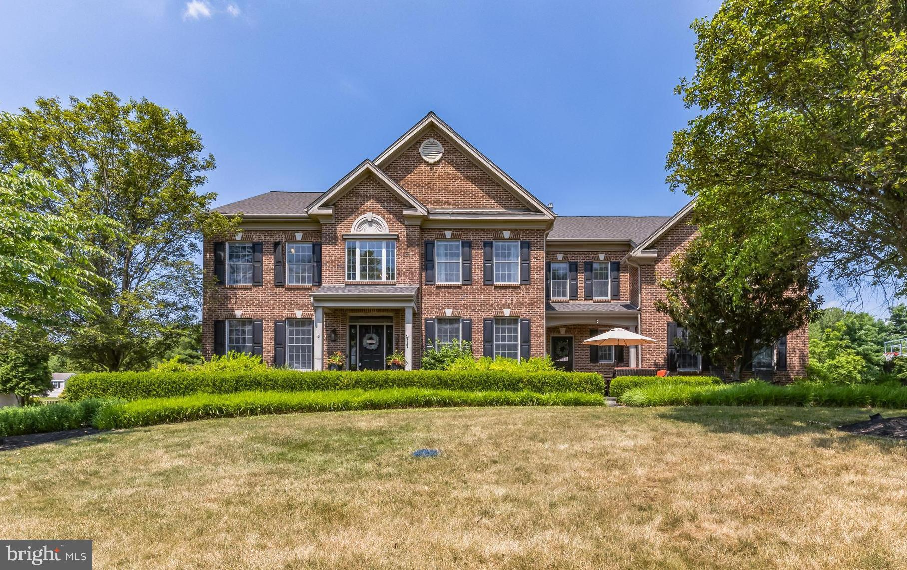 LOCATION, LOCATION, LOCATION! This gorgeous brick front (no stucco) home in sought after High Gate, Ambler/Horsham will not disappoint. The 1-acre lot and the outdoor entertaining area are a few of the many features that will make you want this to be your forever home! The classic brick exterior front has keystones and brick design above the first and second floor windows. There are two covered front porches that welcome you to this fabulous home! One entrance is for everyday use and has a patio and leads to the mud room/laundry room area and coat closet. The other is the perfect entrance for all of your guests and opens to a stunning foyer with beautiful millwork, tile flooring and a gracious front staircase. The foyer is flanked by a formal living room with hardwood flooring and custom built in bookshelves and a formal dining room also with custom woodwork and carpet/hardwood flooring. The living room is such a gorgeous room, and the built-ins give it a cozy feel- a nice spot to relax after work. The dining room can accommodate a crowd and will come in handy for family and holiday dinners. The gourmet kitchen with hardwood floors features new counters and backsplash, gas 5 burner cooktop, double oven, stainless steel sink, tons of cabinet and counter space, desk area and a 10.5-foot center island with pendant lighting and seating for 4. The breakfast room has a vaulted ceiling and amazing windows allowing lots of natural light,  a breakfast bar with seating for 4 and room for a huge table. There is a sliding door to a large outdoor patio with a built-in grill and seating. This area is perfect for summer dining and entertaining. A walk-in pantry closet, a back staircase and access to the 3-car attached garage complete the kitchen area. The spacious family room has a vaulted ceiling, gas fireplace and large opening to the kitchen area which is sure to please the chef in the family.  There is a dedicated first floor office with an adjacent powder room making it easy to work from home.  The second floor offers 5 bedrooms and 3 full baths. The primary bedroom has a gorgeous view of the backyard, ceiling fan, 2 large closets and another room for sitting area or home office. The primary bathroom has a garden tub, stall shower, his and hers sinks and makeup area. The 4 additional bedrooms are all a good size. One has built-in bookshelves, built-in window seat and 2 closets. There is another bedroom with en suite bath with tile floor, double sink and tub. The 2 remaining bedrooms are spacious with plenty of closet space. The hall bath has a double sink, stall shower and tile floor. THE FINISHED WALK OUT BASEMENT IS UNBELIEVABLE and will soon be your favorite spot to entertain. There is a family room/game room area, kitchenette with sink and bar fridge, bedroom, office area, storage area and a full bath. The private bedroom and full bath make this an ideal set up for an au pair. The best part about the basement is that you can walk right out/up to the outdoor entertaining area and gorgeous backyard with lots of space for relaxing and entertaining. The lot is well planted with mature trees and is simply one of the best lots in the entire development. This gem is in absolute move in condition and has a newer roof and gutters. This home is located near schools, library, multiple parks and preserved land for walking, running, and hiking, and you’ll have your pick of multiple shopping areas, popular grocery stores, fantastic dining experiences, award-winning golf courses, major roadways, and quick access to several rail commuting options. HURRY!