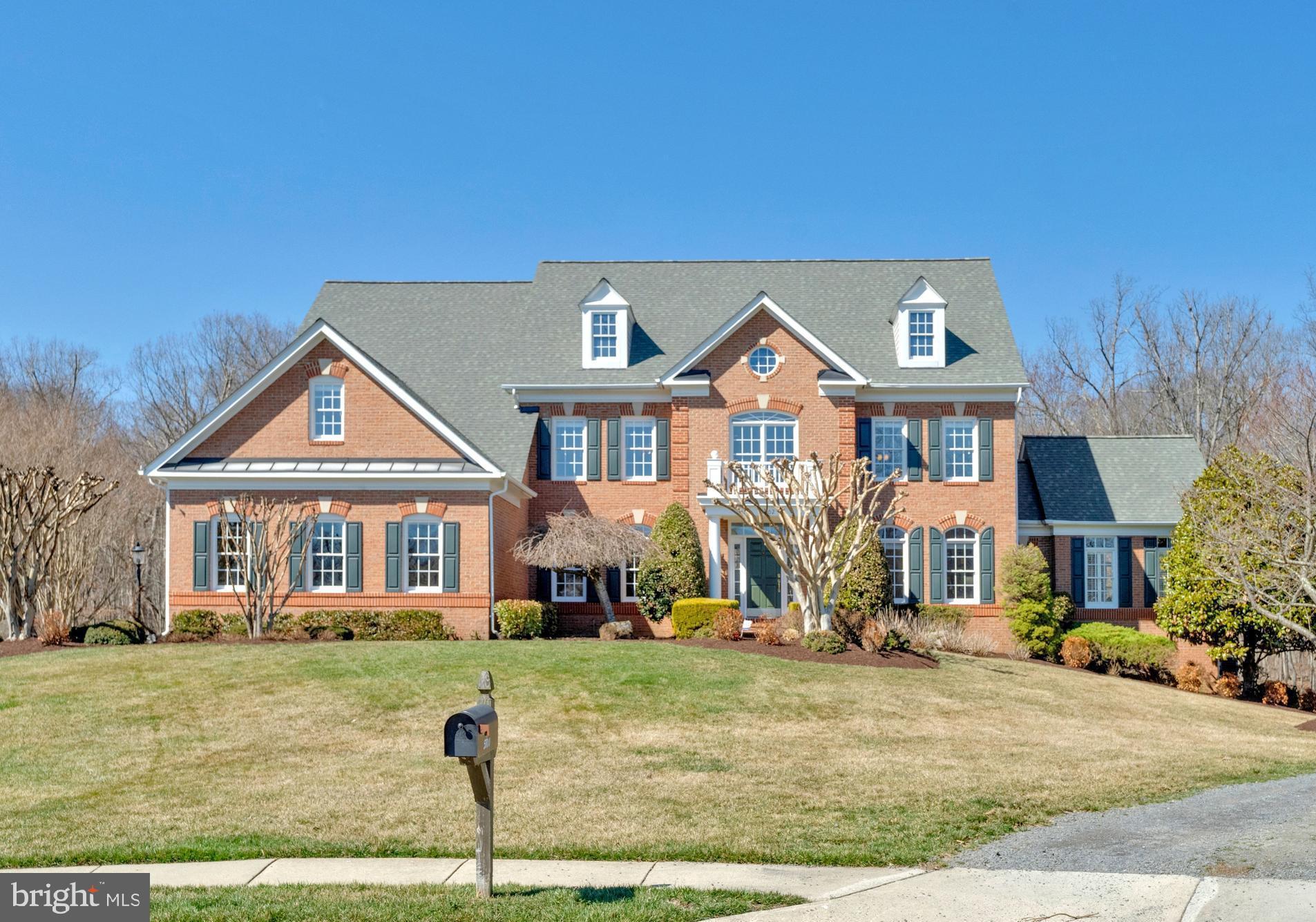 Exceptional estate home in sought-after Virginia Run, beautifully sited on nearly an acre backing to serene parkland at the end of a quiet cul-de-sac. This Stanley Martin built residence offers over 7,000 sq ft of living space, featuring six bedrooms with en-suite baths and a fully finished walk-out lower level designed for both entertaining and comfortable everyday living. Homes offering this level of space, privacy, and parkland views are rarely available in Virginia Run.

A dramatic two-story foyer with a sweeping curved staircase sets the tone, opening to elegant formal living and dining rooms enhanced by soaring ceilings and abundant natural light. The main level also features a spacious morning room, a conservatory, and an impressive two-story family room anchored by a gas fireplace. A wet bar conveniently located just outside the conservatory enhances the entertaining flow.

The kitchen is appointed with maple cabinetry, granite countertops, a walk-in pantry, and a center island with a new GE gas cooktop (2026). It opens seamlessly to both the morning room and a spacious deck overlooking the lush, private backyard. A main-level bedroom suite with full bath provides ideal flexibility for guests, multigenerational living, or a private home office. A secondary rear staircase leads from the kitchen to the upper level, where the wide hallway offers wooded views across the back of the home.

Upstairs, the luxurious primary suite serves as a serene retreat with a sitting area, tray ceiling, generous walk-in closet, and a renovated spa-inspired bath featuring a soaking tub, glass-enclosed shower, dual vanities, and a private water closet (2017). Three additional upper-level bedrooms each enjoy direct bath access, ensuring comfort and privacy for family or guests.

The fully finished walk-out lower level is thoughtfully designed for recreation and entertaining, featuring a bar, expansive game and gathering areas with a gas fireplace, direct access to the private stone patio, and an additional bedroom suite.

Extensive updates include: roof (2023), water heater (2022), fresh interior paint (2026), exterior paint (2025), new GE gas cooktop (2026), hardwood flooring added in the primary bedroom (2017), new carpet in two upper-level bedrooms, upper-level bath refresh (2026), and driveway resealed (2025).

Outdoor living is exceptional, with two decks, a stone patio, irrigation system, professional landscaping, and mature trees creating a peaceful, park-like setting. The flat backyard offers both privacy and usable outdoor space, ideal for entertaining, play, or quiet relaxation.

Located within the sought-after Virginia Run community, residents enjoy access to a pool, tennis and pickleball courts, clubhouse, and scenic walking trails, all conveniently close to Routes 28, 66, and 50, as well as Washington Dulles International Airport.