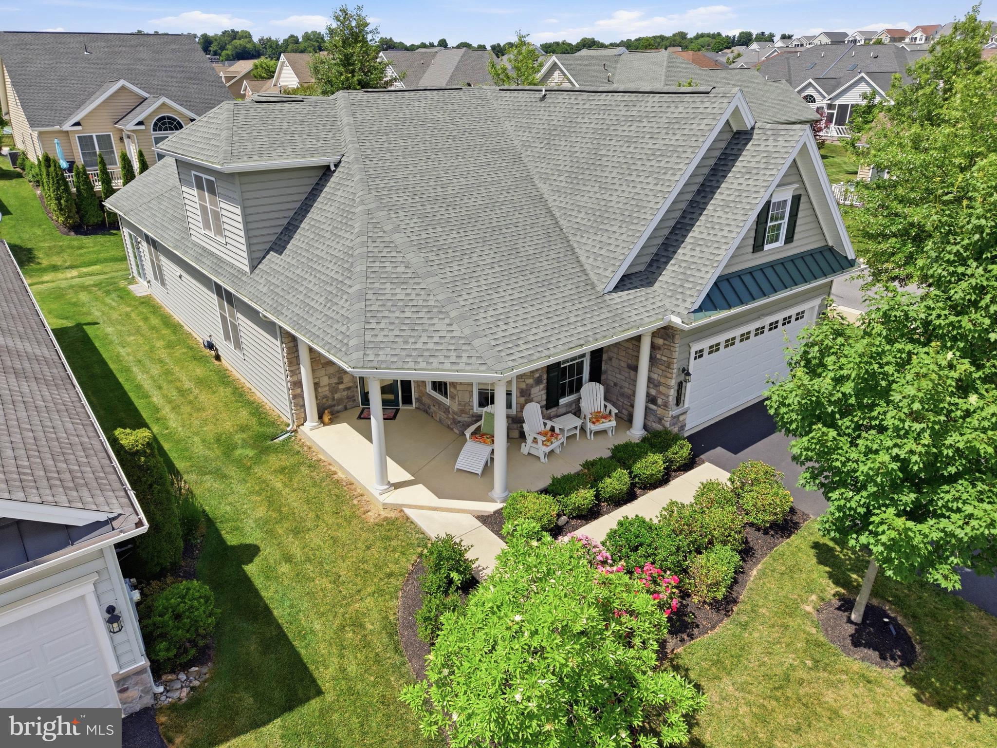 Welcome to 1063 Presidents Drive—a beautifully maintained 3-bedroom, 2 full and 1 half bath home offering 2,776 square feet of thoughtfully designed living space in the Traditions of America at Lititz 55+ Community. Perfectly positioned on a premium corner lot, this exceptional residence enjoys scenic views of neighboring farmland from the welcoming front covered patio, offering a setting that is both peaceful and unique within the community.

Inside, a bright and inviting floor plan showcases soaring ceilings, elegant finishes, and an abundance of natural light throughout. The welcoming foyer opens to a private office/den and formal dining room, creating a functional layout that balances comfortable everyday living with effortless entertaining. Rich engineered hardwood flooring, crown molding, recessed lighting, and thoughtfully designed architectural details enhance the home's warm and sophisticated atmosphere.

At the heart of the home is a beautifully appointed kitchen featuring gorgeous corian countertops, abundant cabinetry, a spacious center island, breakfast bar seating, and a sunny breakfast nook. The kitchen flows seamlessly into the impressive great room, where 2-story cathedral ceilings and expansive windows create an open and airy gathering space ideal for hosting family and friends. Just beyond, the rear sunroom provides an exceptional retreat and is larger than many found within the community. Complete with a gas fireplace and panoramic views of the backyard, it serves as the perfect place to relax year-round while enjoying the surrounding landscape.

Designed for convenient single-floor living, the main-level primary suite offers a spacious private retreat featuring a walk-in closet and a beautifully appointed en-suite bath with a walk-in shower and elegant finishes. A second main-level bedroom, full bath, and dedicated laundry room provide additional convenience and flexibility for guests or everyday living.

Upstairs, a generously sized third bedroom is accompanied by a full bath and versatile loft area, creating an ideal space for visiting guests, hobbies, a reading lounge, or additional workspace. An adjoining storage room provides valuable additional storage.

The oversized attached 2-car garage offers built-in storage, workshop potential, and convenient interior access.

Residents of Traditions of America enjoy an exceptional low-maintenance lifestyle with HOA services that include lawn care and snow removal, along with access to outstanding community amenities including a clubhouse, fitness center, swimming pool, pickleball courts, walking trails, library, shuffleboard, and beautifully maintained common grounds. Conveniently located just minutes from downtown Lititz, shopping, dining, healthcare, and major commuter routes, this exceptional home offers the perfect blend of comfort, convenience, and active adult living. Schedule your private showing today!