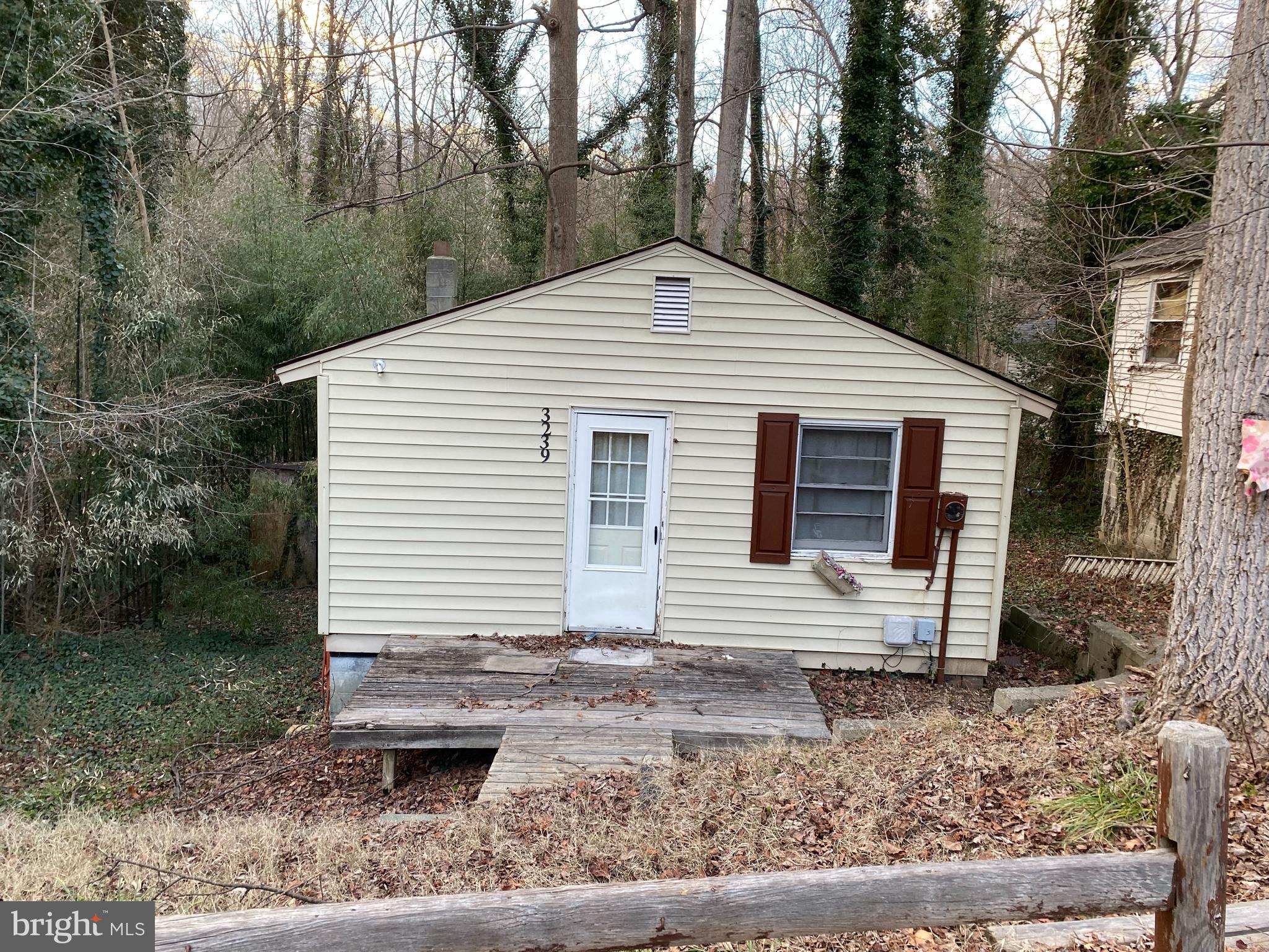 Tiny House living possibilities! This home is located in a great waterfront community with a community beach and pier. Property backs up to the American Chestnut Land Trust property.  Home needs some work.  Lower level has some organic growth near the front of the house.  Sold strictly in 'as is' condition.    Come by and see if this could be your new tiny house!