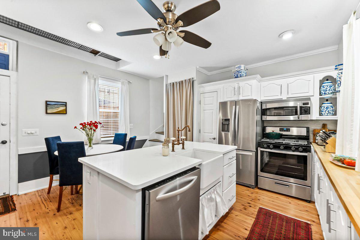 A thoughtfully updated Trinity tucked along a quiet, tree-lined block in Rittenhouse Square, offering a rare blend of light, outdoor space, and refined city living.

Located in the heart of Rittenhouse Square, this sun-filled 2-bedroom, 1.5-bath home blends classic Philadelphia character with modern comfort, thoughtful updates, and flexible living space. With both north and south exposures, the home enjoys beautiful natural light throughout the day.

The updated kitchen is designed with both style and function in mind, featuring white shaker cabinetry, butcher block countertops, a custom white quartz island, farmhouse sink, gas cooking, stainless steel appliances, pantry storage, and a built-in spice rack.

Just off the kitchen, a private yard offers a rare outdoor retreat in the city, ideal for morning coffee, evening dining, or warm weather entertaining.

The second level is bright and versatile, currently styled as living space and enhanced by a built-in Murphy bed for added flexibility. This floor also includes a full bath with Carrera marble, tub/shower combo, linen closet, and a stackable washer and dryer with additional storage.

The top floor is arranged as the primary suite, complete with an en-suite half bath, exterior vanity area, three spacious closets, and blackout cellular shades for added comfort.

Wide-plank cypress hardwood floors extend throughout, adding warmth and continuity to the home’s thoughtfully designed interior.

Located just steps from Rittenhouse Square and one block from South Street, the home offers easy access to dining, shopping, public transportation, and everyday conveniences, while maintaining a quieter, more residential feel within the city.