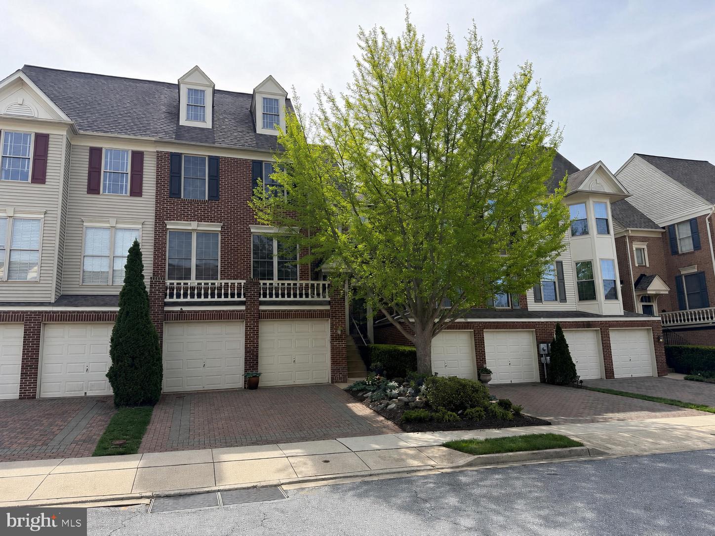Coming Soon — Homes of this caliber are a rare find. Meticulously maintained and beautifully presented, this picturesque townhome is nestled in one of Frederick’s most desirable communities, Wormans Mill, where residents enjoy a community pool, clubhouse, and true low-maintenance living with lawn care included. An added bonus of this neighborhood is the walkability to many restaurants, shops, and retail stores. From the moment you arrive, the paved driveway and distinctive two-car garage create a striking first impression. Inside, the entry level from the garage offers exceptional flexibility—the main space in the basement is ideal for a recreation room, home gym, or guest space, and a den or potential fourth bedroom is nestled in the basement as well. The main living level has many windows, allowing natural light to fill the home and highlight the rich, well-maintained oak hardwood floors. The thoughtfully designed kitchen has been impeccably maintained. A unique three-way fireplace between the kitchen and family room provides both warmth and architectural character, subtly defining the kitchen and living areas while maintaining an open, inviting flow. Step out onto the deck from the kitchen, which overlooks a beautifully landscaped, paved backyard that blends softscape and hardscape elements, offering year-round visual appeal. Two mature crepe myrtle trees provide beauty and shade, making it an ideal space for family gatherings and entertaining. From the deck and patio below, you'll enjoy a view of the spacious grassy common area, surrounded by tall mature trees and perfectly maintained by the HOA, providing added privacy and the setting of a serene, park-like backdrop. The upper level features three bedrooms and two full bathrooms. The primary suite is spacious with vaulted ceilings and includes his-and-her closets, along with a beautiful, newly remodeled bathroom featuring double sinks, a soaking tub, and a separate shower. Above the primary suite is a loft, a perfect space for an office or private retreat. This is an exceptional opportunity to own a move-in-ready home in one of Frederick’s most sought-after neighborhoods.