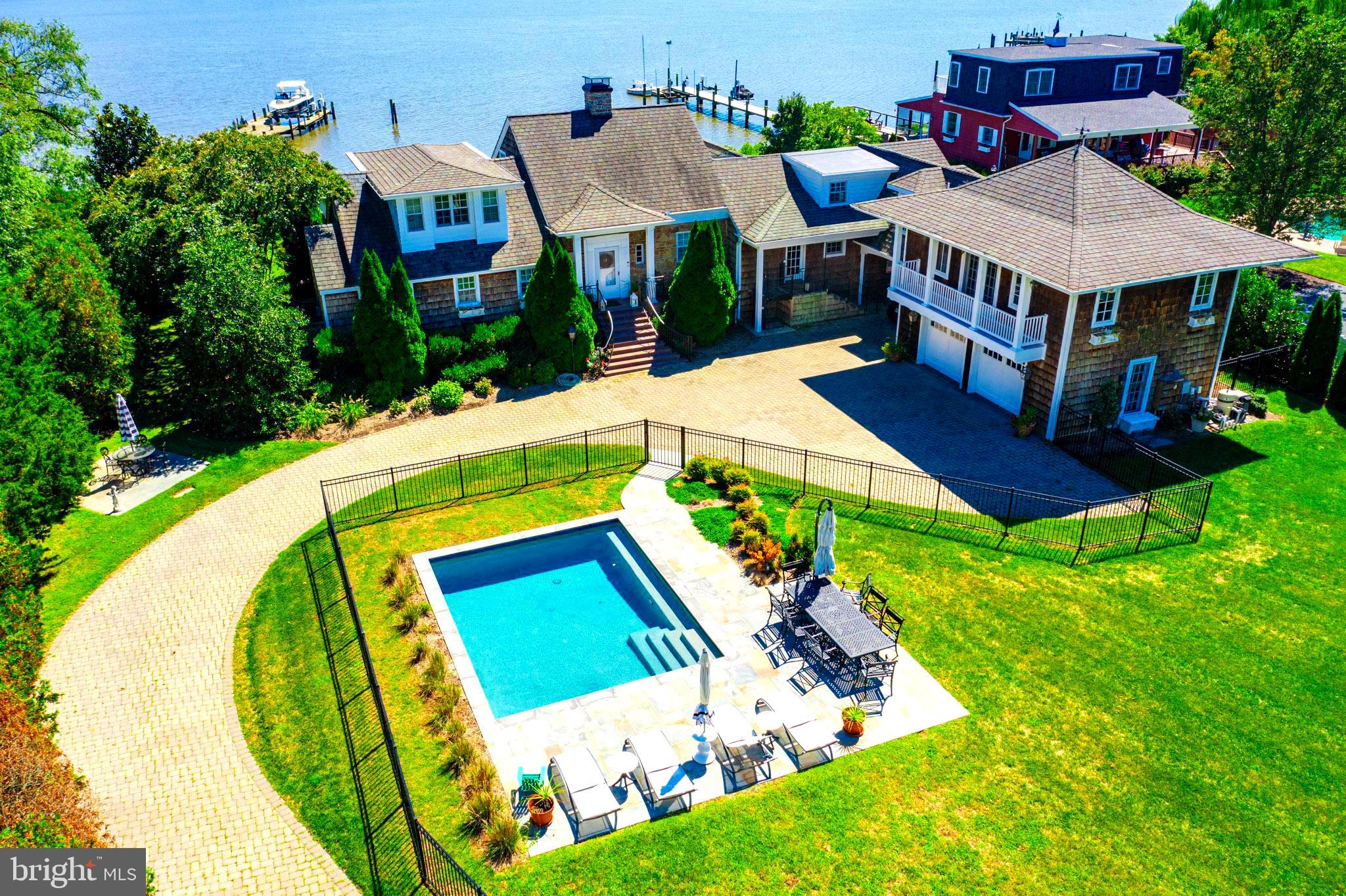 Price Improvement! Spectacular waterfront on the Chester River!!  Words can't describe the uniqueness of this property.  With the historic charm of an older home but  high end modern upgrades, you will be living the life of luxury.   Spacious rooms, magnificent views of the Chester River and your private dock with new boat lift, sandy beach, and stunning new saltwater pool.  Exposed beams, scalamandre wallpaper, and multiple fireplaces.  First floor owners suite featuring reclaimed pine flooring, private laundry area, walk-in closet, gas fireplace and remodeled bath with soaking tub. Second floor owner's suite with additional laundry area and remodeled bath.  Breezeway to the garage. New irrigation system to all flower beds. New paint inside and out.  House has had major remodels in 2000 and 2020. Town sewer.   Not far from town, but the property has a private feel.   Come and be amazed!!