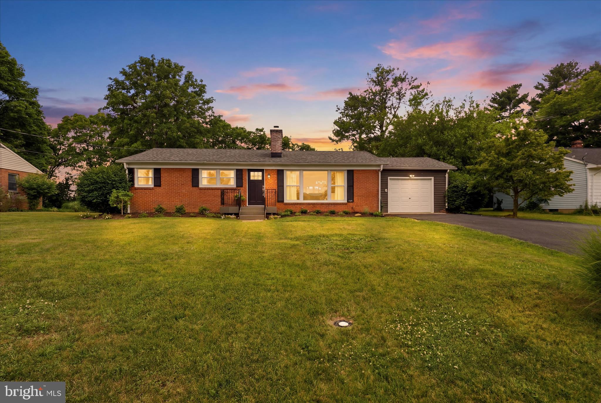 Welcome to this beautifully updated brick ranch on a nearly half-acre lot in Berryville’s desirable East side. Offering over 3,000 square feet of living space, this home features hardwood floors, neutral paint, a bright picture window, and a spacious country kitchen with updated countertops, breakfast bar, pendant lighting, and abundant storage. The main level includes a primary bedroom, an additional bedroom, an updated full bath, and an oversized laundry/mudroom with built-in storage!  The finished walk-out basement provides exceptional flexibility with a large family room featuring a wood-burning fireplace, full bath, 3rd bedroom, workshop, and utility space. Outdoor living shines with a Trex deck, stone paver patio, and expansive, tree-lined and fenced backyard offering privacy and room to entertain. Recent updates include $20K in improvements including a new driveway, egress window, new roof (2020) and garage door opener (2022). Conveniently located near commuter routes, Rt 7, shopping, and local amenities, this move-in-ready home combines modern updates with small-town charm.