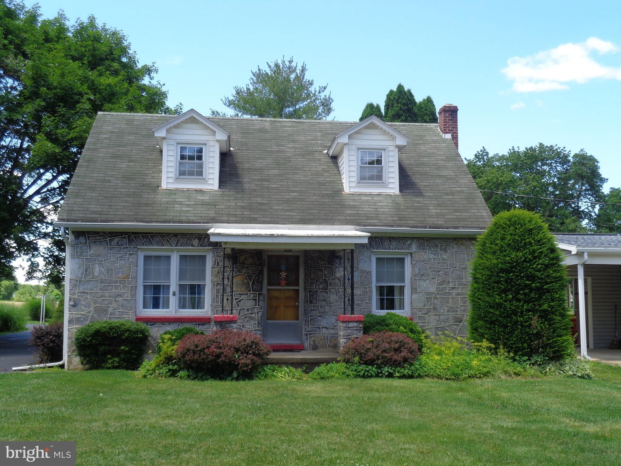 Cute-as-a-button Cape Cod with a nice rural setting. Stone front & vinyl-siding, detached 2-car garage with metal roof, sunroom with wood stove, 1st-floor bedroom, central-air on 1st floor of the home but not on 2nd floor, oil hot-water baseboard heat with EBB units upstairs, 3/4 basement with crawl space under kitchen and more.