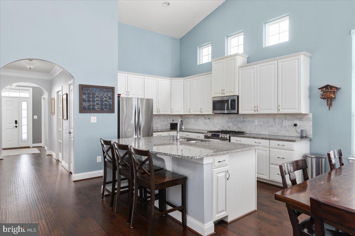 Welcome to your forever home! With over 4,000 square feet of living space and an attached two-car garage, this property offers the perfect blend of style, functionality, and comfort. The stunning open design and main-level living provide endless possibilities to make it uniquely yours. Arched openings, vaulted ceilings, and wide-plank engineered dark hardwood floors lend a modern and sophisticated feel throughout.

The home features three spacious bedrooms on the main level, with the flexibility to use the study as a fourth bedroom if needed. The owner’s suite is a private retreat with two walk-in closets, a luxurious double shower with a bench, dual sinks on a comfort-height vanity, and a private water closet—your own personal oasis. Two additional bedrooms with Elfa closets and an upgraded hall bathroom are conveniently located in the center of the home, alongside a mudroom and laundry area thoughtfully designed to maximize space.

The kitchen is a delight for any cook, offering a stainless steel double sink with ample counter and cabinet space, a custom marble backsplash, and upgraded granite countertops with a breakfast bar. The dinette and great room are seamlessly connected to the kitchen, making them ideal spaces for entertaining or relaxing. Just off the great room, a 515-square-foot flagstone patio and a fenced, level backyard extend your living space outdoors, perfect for gatherings and activities.

This home is packed with modern conveniences, including overhead lighting in every room, custom blinds on all windows, a 50-amp outlet in the garage for your electric vehicle, and a full 10kWh solar power system with a transfer switch for energy storage, allowing you to enjoy little to no power bills or even go off-grid.

The finished basement adds nearly 2,000 additional square feet of living space, offering luxury vinyl plank flooring, recessed lighting throughout, and a rough-in for another bathroom, giving you endless options for customization. This level also includes a large room with a walk-in closet, a movie room with QuietRock ceiling panels for soundproofing, and several storage closets to keep your life organized.

When you’re ready to venture out, you’ll find the abundant amenities of Virginia Manor at your doorstep. Two clubhouses with outdoor pools, a state-of-the-art fitness center, tennis courts, tot lots, over ten parks, and miles of paved trails provide endless opportunities for recreation and leisure.

Don’t let the ranch style fool you—this home offers an incredible amount of space, comfort, and convenience. Just minutes from major commuting routes, shopping, dining, and neighborhood schools, it’s the perfect place to call home.