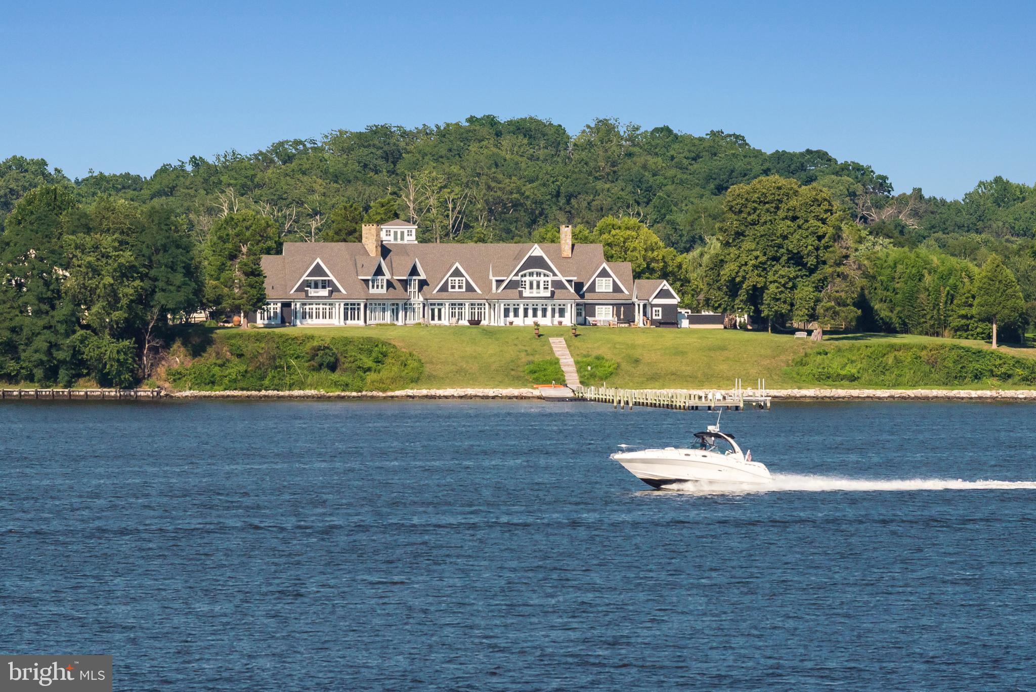 Sited on 1.7 acres on prestigious Melvin Point with incredible water views and 360 ft of water frontage and southwest exposure, pier, heated pool, tree house, 2 outdoor showers & fire pit for year-round retreat living. Living space maximizes expansive sightlines; sleek custom cabinetry, wet bar, main level master suite &  motor court. Appraisers: Call LA for details.