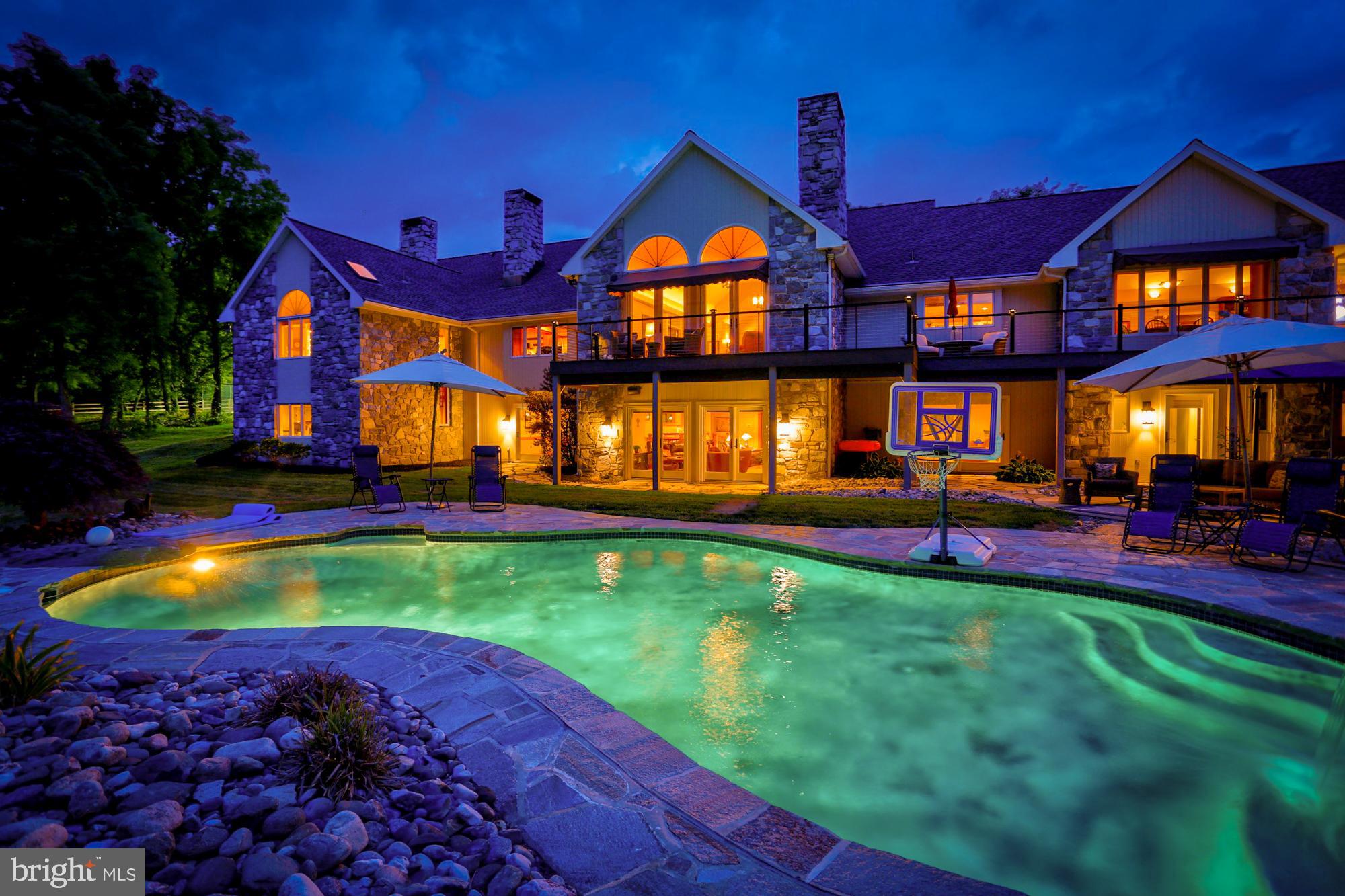 TOUR THIS HOME NOW: https://www.zillow.com/homes/9-Waterfront-Estates-Dr-Lancaster,-PA,-17602_rb/9692934_zpid       You've NEVER seen a home like this in Lancaster! Old world craftsmanship highlights this French country gray stone home w/ 9,000 sq/ft of living space w/unparalleled amenities & privacy. Completely renovated in 2014/ 2015 - Stunning stone rancher w/beautiful creek front 5+ acre fenced, private wooded lot w/majestic view, swimming pool/hot tub, lighted tennis/basketball court. NEW 50-yr roof, gutters, Gutter Helmet, downspouts, fascia, soffit, & skylights replaced Fall 2017! All NEW Anderson exterior doors installed Fall 2017.  SONOS throughout home provides for high fidelity sound in every rm. Unprecedented natural light from LRG windows covered with 3M tinting to protect your flrs & furniture. Enter the custom, hand-carved 8-ft mahogany double doors to a spacious Italian marble flr cathedral foyer. Foyer leads to a formal liv rm w/cathedral ceiling, marble surround gas fp w/elaborate marble & wood mantle, custom trim w/LED accent up-lighting, & 4 glass drs leading to the TimberTech deck overlooking Mill Creek. 5 spacious bdrms each w/their own custom, full bath w/granite counters. Lrg gourmet kitchen completely renovated w/a large quartz island, granite tops & custom tile backsplash. All NEW appliances - Sub-Zero double fridge/freezer, 60-bottle wine cooler w/refrigerated drawers & ice machine, Thermador double oven, Wolf cook top, Jenn-Air cook top, & 2 Bosch dish washers. Antique white glazed cabinets include beaded glass doors, a desk area w/granite blends nicely w/the new hand-scraped wide plank hdwd flrs. Kitchen is complemented by a separate, lrg butler's kitchen w/abundant preparation & storage. Formal dining rm has a tray ceiling, art accent lighting, wainscoting, & a spectacular hdwd parquet flr. Connected w/the HUGE kitchen is a spacious fam rm w/cathedral ceilings & flr to ceiling stone fp. Custom-built maple hdwd entertainment center.  There's a stunning library/ office w/a coffered ceiling, lighted cabinets, marble-surround fp w/custom mantle, custom raised-panel cherry cabinetry & trim, new Marvel refrigerator, wet sink, & new varied-width hdwd flrs.  The HUMUNGOUS master suite bath boasts a large walk-in, 5 head full marble shower w/seating, towel warmer, & skylight. Other master bath features include a soaking tub overlooking the rear of the property, heated marble frs, double sinks, 2 giant WICs, a cedar closet, washer/ dryer & 5 sky lights. Exit the French doors from the master bath to your master bedrm including a romantic marble surround gas fp, a custom-built raised panel maple entertainment center & mantle, & four glass doors leading to your private oasis on the stone patio overlooking the wooded lot & tennis court. An incredible custom oak spiral staircase leads to the finished L/L which includes 3,500 sf of additional living space. L/L includes a full gym w/new rubber mat flooring, flr to ceiling mirrors, a sauna, & full bath. For the aspiring golfer there s even an indoor driving range. In addition, there s a lrg recreation area w/a custom antique Brunswick slate pool table, & custom crafted oak wet bar w/granite counters. 2 home theatres w/awesome surround sound! There's a complete in-laws quarters w/lrg fam rm, newly renovated full granite bath & custom kitchen w/granite & ss appliances. The L/L also includes massive closet space & an enormous unfinished area for storage. Screened-in porch w/a peaceful view overlooking the back yard & a koi pond w/2 waterfalls.  A Sylvan & Anthony pool w/diving board, NEW propane heater & all NEW Pentair pool equipment w/an elegant waterfall hot tub. The entire rear of the home is complemented w/a NEW 1,200 sf multi-level TimberTech deck w/amazing views unparalleled in Lancaster.