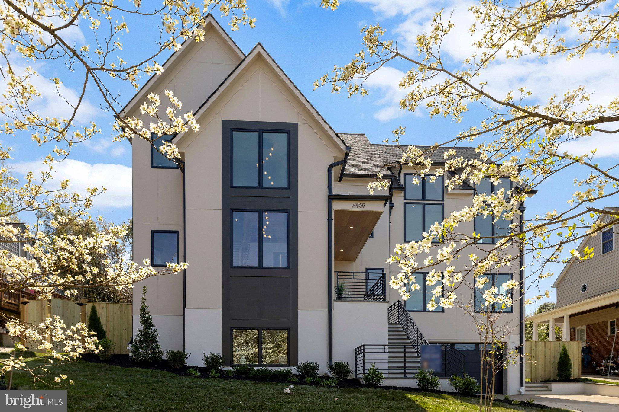 Welcome to this exceptional new construction home in the heart of McLean, where thoughtful design meets everyday luxury. Built with quality, functionality, and style in mind, this home offers a seamless blend of open living spaces and high-end finishes throughout.
The main level is designed for both entertaining and daily living, featuring an open floor plan with 7-inch engineered hardwood floors, custom trim work, and abundant natural light. The gourmet kitchen is a true centerpiece, showcasing custom two-tone cabinetry, a massive 12-foot quartz island with seating for six, glass-front cabinets, and a full suite of premium stainless steel appliances—including a 60-inch refrigerator, professional 8-burner range with double ovens, and a powerful 1200 CFM hood. A hidden butler’s pantry and separate prep/spice kitchen (complete with its own stove and sink) provide extra functionality while keeping the main space clean and elegant.
The dining area features coffered ceilings and large windows, while the adjacent living space flows effortlessly to a screened-in porch with custom tile—perfect for indoor-outdoor living. A flexible main-level room can serve as an office, formal living space, or in-law suite, complete with storage and washer/dryer hookups.
Upstairs, the bedroom level is designed for comfort and convenience. Each bedroom includes a walk-in closet and a ceiling fan connection, while the primary suite stands out with a custom closet system, a spa-inspired bath with designer tile, a glass shower, and a chandelier over the soaking tub. A full laundry room with sink and cabinetry, plus additional laundry space, adds everyday ease.
The fully finished basement expands the living space even further, offering a large recreation area, a bedroom with en-suite bath, and space ideal for a home theater or gym—already wired for a projector. Tile flooring throughout the lower level adds durability and a clean, modern look.
This home is loaded with upgrades that set it apart: custom lighting throughout, recessed LED lighting, baseboard lighting accents, two large fireplaces, and smart wiring for TV and cable. Built with a roof truss system for open spaces, the home also includes an elevator shaft for future installation.
Exterior features are just as impressive, with durable Hardie siding, a metal roof, black gutters with guards, custom iron railings, and professionally graded landscaping. The property also includes a 2-car garage with a 50-amp EV charging outlet and an upgraded 400-amp electrical service.
Additional highlights include a two-zone HVAC system, multiple storage areas, a mudroom, and a builder's warranty for peace of mind.
This is a rare opportunity to own a truly move-in-ready, thoughtfully upgraded home in one of Northern Virginia’s most sought-after locations—offering both luxury and practicality in every detail.