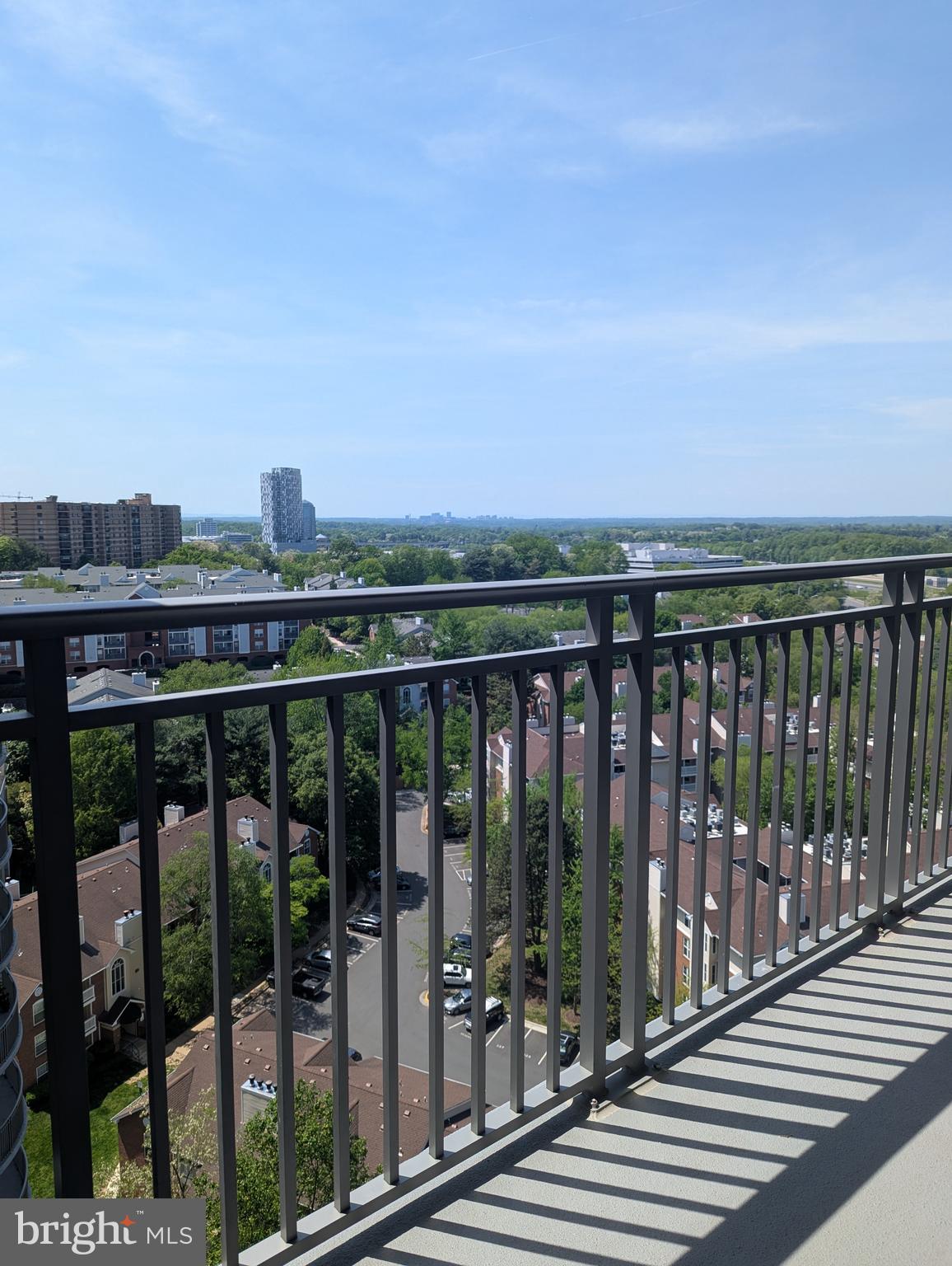 Luxury condo building - this 15th floor unit features floor to ceiling windows with serene views from living room, bedroom, and balcony. Assigned garage parking space. Washer and Dryer in unit. ADDITIONAL Storage Bin. Hardwood flooring from entry thru kitchen, dining, and living space that accesses balcony. Granite countertops, stainless appliances, breakfast bar. Ceramic tile and granite in bathroom. Bedroom with wall of windows and walk-in closet. Enjoy extensive amenities to include rooftop pool, grilling area, and billiard table in party room. Secure building with fitness room, library, gorgeous lobby and concierge. Residents can reserve guest suites too. Location is next to Starbucks and Harris Teeter, 1/3 mile to Tysons Galleria, less than a mile to Tysons Corner metro. Tenant pays electric. Owner condo fee includes gas for heat and cooking plus water and sewer. NOTE - property is currently tenant occupied and vacant photos of interior are representative of space.