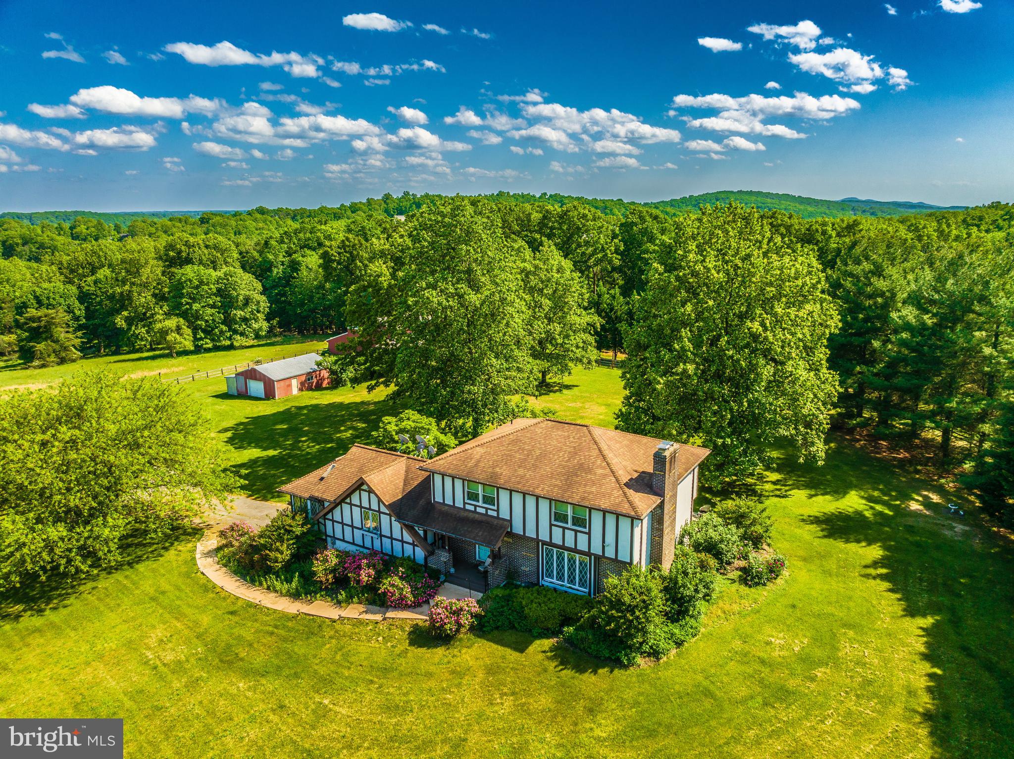 Escape to a serene 51-acre retreat that offers both peace and privacy. This charming three-bedroom, three-and-a-half-bath farmhouse features hardwood floors throughout and a fully finished walkout basement. Each bedroom provides stunning landscape views, ensuring a restful stay.

Designed to accommodate both crop and livestock farming, the property is equipped with barns suitable for raising horses, cows, chickens, sheep, and goats. Modern amenities include new kitchen flooring, basement flooring, underground Xfinity gigabit high-speed internet cable and TV, fire pit, hot tub, and garage parking with an EV charger, and pet-friendly policies.

The living room and basement each boast a cozy fireplace, complemented by a patio, deck, sunroom, and a covered front porch—all perfect for taking in the picturesque surroundings. The basement living space, complete with a full bathroom, is wheelchair accessible from the garage, ensuring comfort for all guests.

Conveniently located just an hour from Washington, D.C., and Baltimore, and a mere five-minute drive to downtown Frederick, MD, this property offers the perfect blend of rural tranquility and urban accessibility.