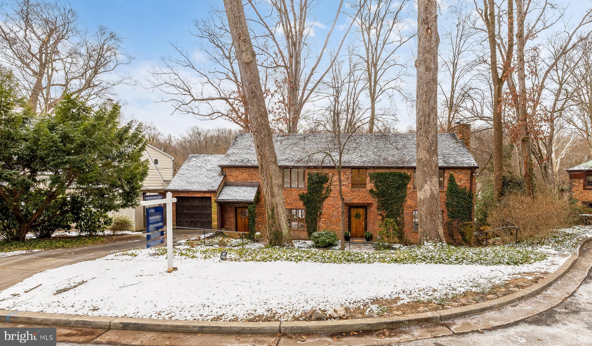 Welcome to Westmoreland Hills

Step into this exceptional classic Tudor, where timeless English cottage charm meets refined architectural elegance. Tucked away at the end of a peaceful cul-de-sac and backing to acres of protected parkland and rolling meadows, this remarkable residence offers breathtaking scenic views and a rare sense of privacy and tranquility.

A major renovation and thoughtfully designed addition in 2005, led by renowned architect Suzanne Reatig, transformed the home, introducing striking leaded glass walls that frame sweeping wooded vistas and flood the interior with natural light, complemented by luxurious radiant floor heating

The home features four spacious bedrooms and four full bathrooms thoughtfully arranged across two levels.
The upper level offers two bedrooms and two full baths, while the lower level includes two additional bedrooms and two full baths, highlighted by a private suite complete with its own kitchen, living area, full bath, and direct access to the backyard—perfect for guests, in-laws, or an au pair.

The serene primary suite is a true retreat, featuring a private lounge or den overlooking dramatic floor-to-ceiling glass walls and captivating natural views. A second expansive living room, anchored by a cozy fireplace and surrounded by walls of windows, invites intimate evenings by the fire—wine glass in hand—while soaking in the ever-changing beauty of the surrounding meadows.

The beautifully renovated kitchen is equipped with stainless steel appliances and opens seamlessly to a sun-filled dining room that comfortably accommodates a table for eight, making it ideal for both everyday living and effortless entertaining.

Additional highlights include a one-car garage with driveway parking, lush professionally landscaped grounds, and a rear terrace perfect for outdoor gatherings or quiet moments in nature.

Ideally located just moments from Westmoreland Park, tennis courts, the Capital Crescent Trail, Spring Valley, Friendship Heights, and Downtown Bethesda, with quick access to Georgetown, the Kennedy Center, the White House, and Washington, DC’s most celebrated cultural and commercial destinations.

This is a truly rare opportunity to experience timeless elegance, exceptional privacy, and natural beauty in one of the region’s most coveted neighborhoods.