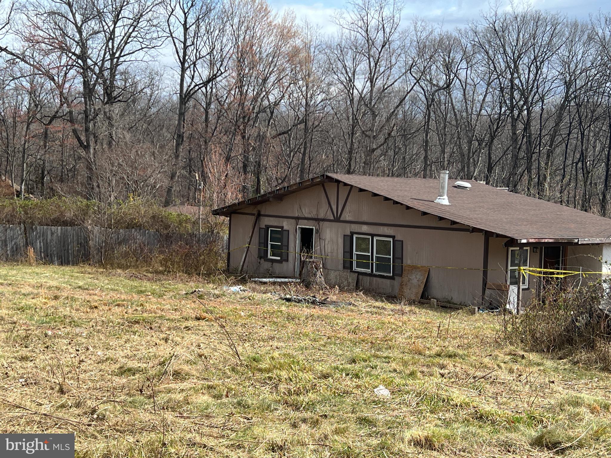 Situated in the Shenandoah Farms community  of Front Royal, just roughly 1 mile to Shenandoah River. 704 Western Lane offers an opportunity for investors, builders, or buyers seeking a property with redevelopment potential. The parcel includes an existing structure; however, the structure is not considered safe and should not be entered by buyers or agents.

The property currently utilizes a well and septic system that are shared with an adjacent property and are reportedly in use. Documentation related to these systems—including permits, surveys, agreements, or health department records—is not available. The seller has stated there are no known liens on the property. Buyers should perform their own due diligence to determine the location, functionality, legality, and adequacy of the well and septic systems for any future use.

This property is located within a Sanitary District and is being sold strictly AS-IS with no warranties or guarantees, either expressed or implied. Purchasers are responsible for verifying all property details, including utilities, zoning, lot boundaries, access, structure condition, permitting requirements, and feasibility for renovation or new construction.

Residents of Shenandoah Farms enjoy access to community features such as lakes, trails, playgrounds, and outdoor recreation areas, along with nearby public access to the Shenandoah River. Local parks and community resources further enhance the appeal of the surrounding area.

Whether the plan is to renovate, rebuild, or develop, 704 Western Lane presents a chance to bring new vision to a property located within an established and amenity-rich community.